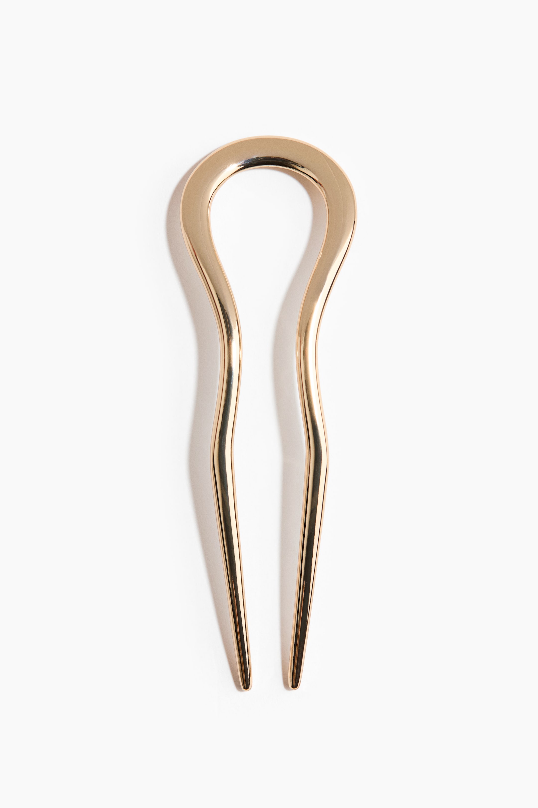 View larger image: "A gold-toned hair pin featuring a rounded U-shaped top, with two gently curved prongs extending downwards, tapering to rounded tips."