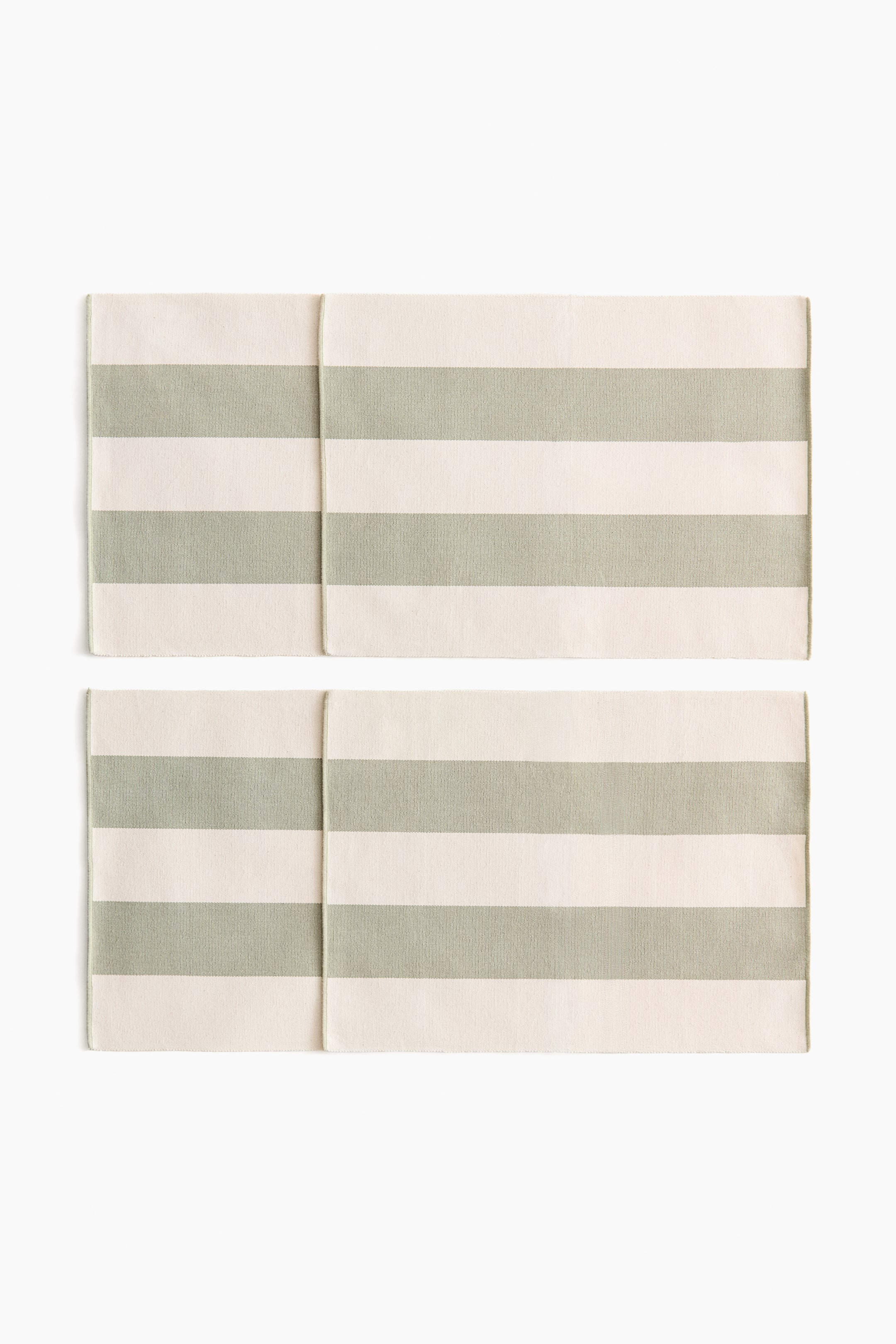 View larger image: Two rectangular placemats are displaying a horizontal striped pattern. The stripes are alternating between off-white and sage green.