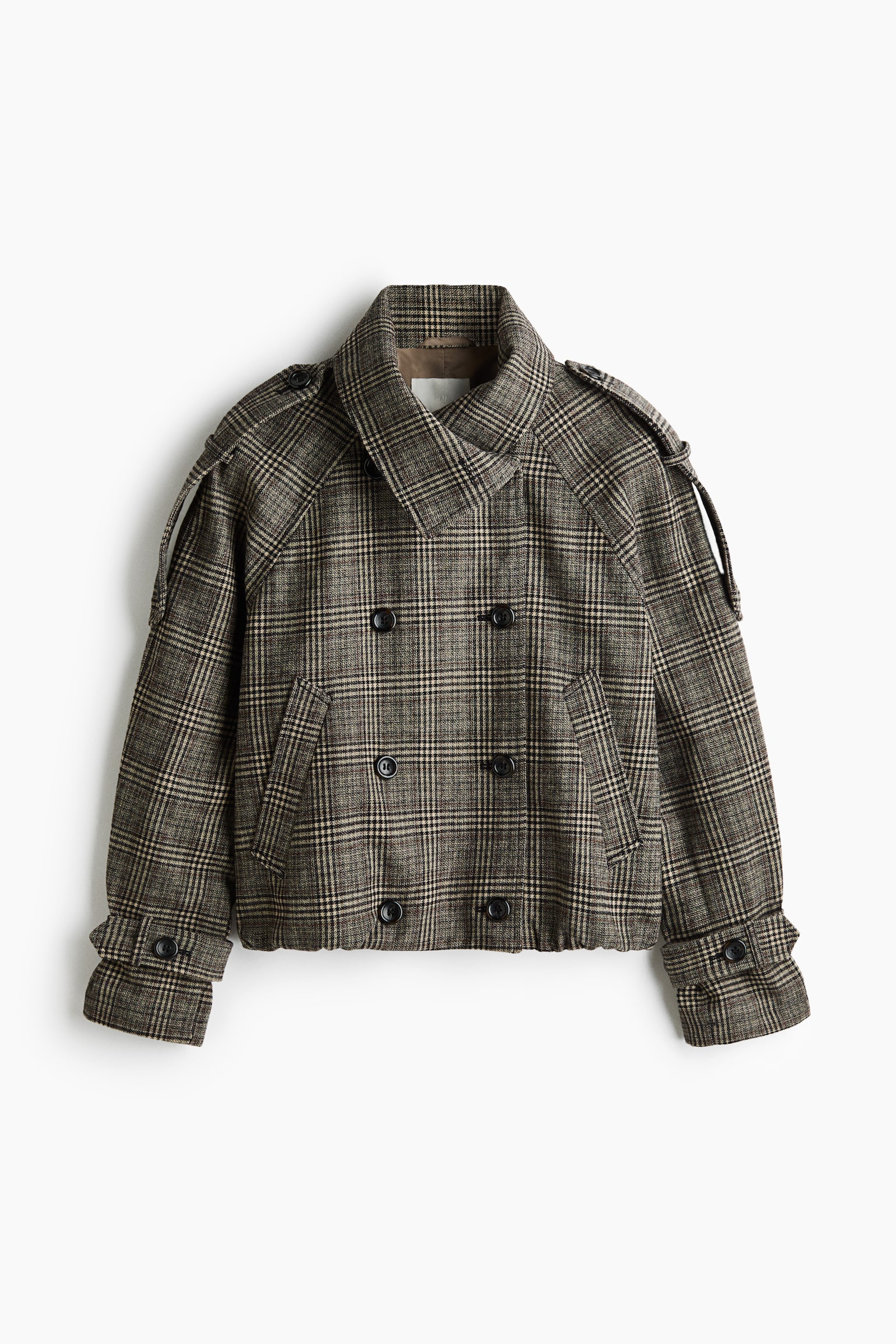 A short, double-breasted jacket in a brown and beige plaid pattern is shown from the front, featuring a high funnel collar, buttoned shoulder epaulettes and raglan sleeves. The jacket has a six-button front fastening, slanted welt pockets, buttoned cuff tabs and a gathered bubble hem.