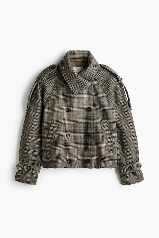 A short, double-breasted jacket in a brown and beige plaid pattern is shown from the front, featuring a high funnel collar, buttoned shoulder epaulettes and raglan sleeves. The jacket has a six-button front fastening, slanted welt pockets, buttoned cuff tabs and a gathered bubble hem. - 1