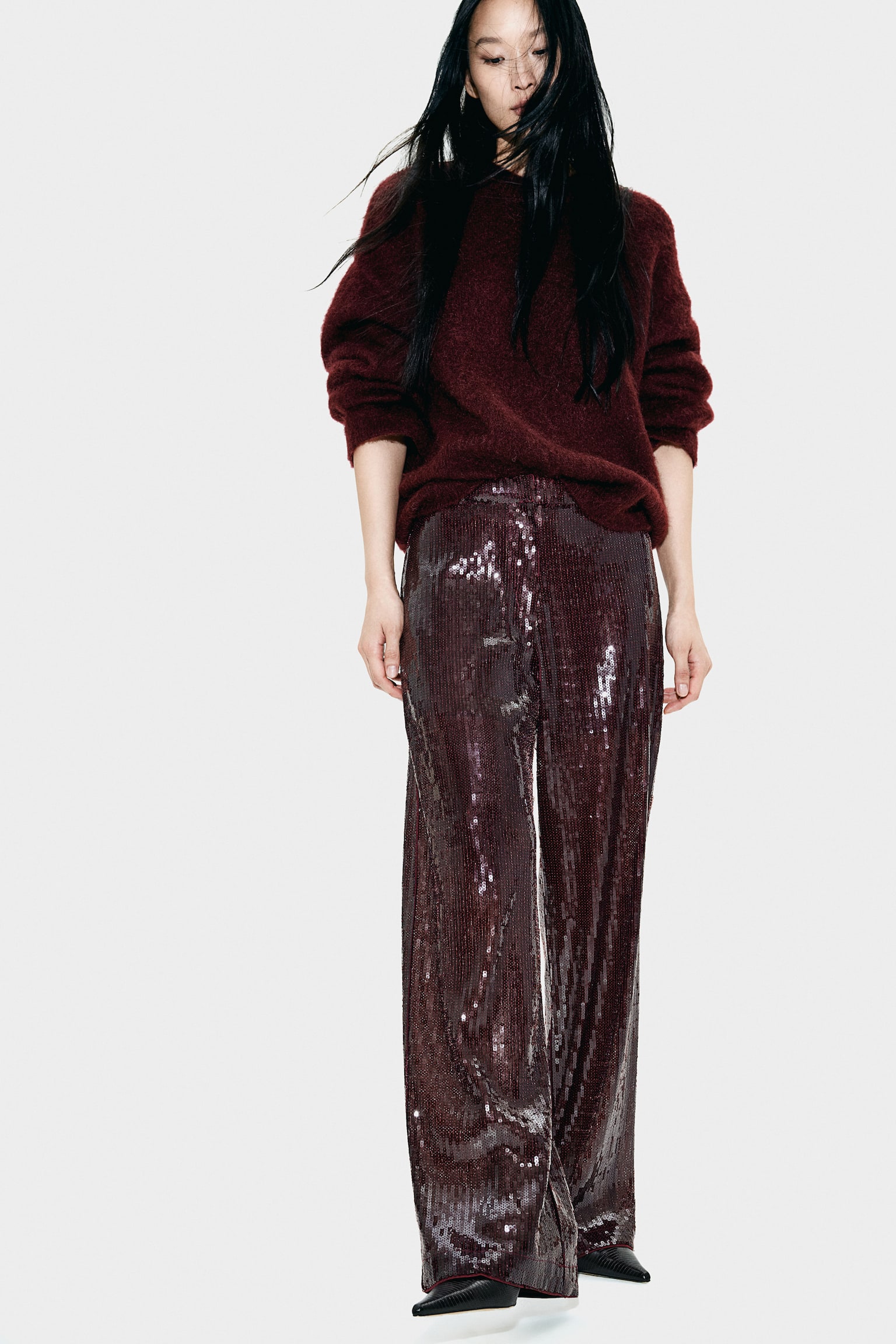 christmas party outfit trends 2024 - burgundy sequin trousers by H&M 