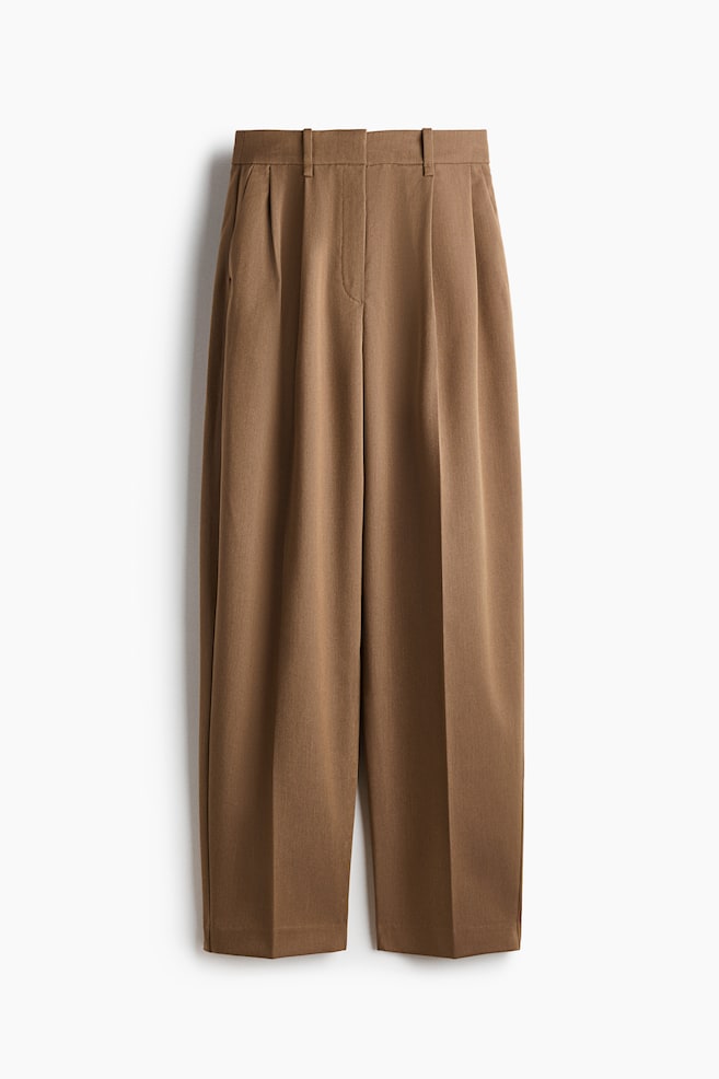 The brown trousers are featuring a high waistband with belt loops, front pleats, and side slash pockets, presenting a wide-leg, cropped silhouette. - 1