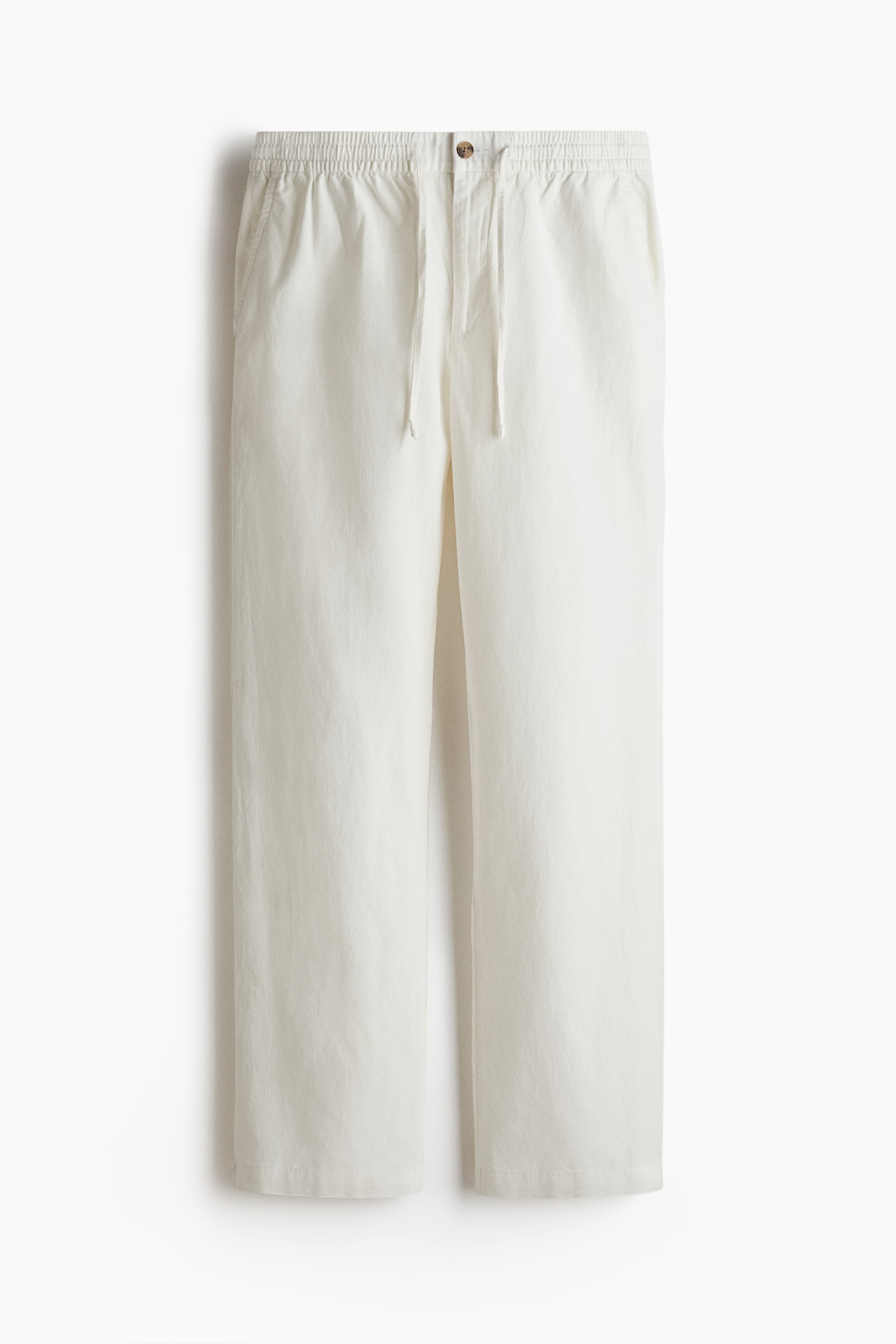 View larger image: The off-white pants are presenting from the front, featuring a relaxed straight-leg fit. They are designed with an elasticized waistband, a visible drawstring, a single brown button, and two side pockets.