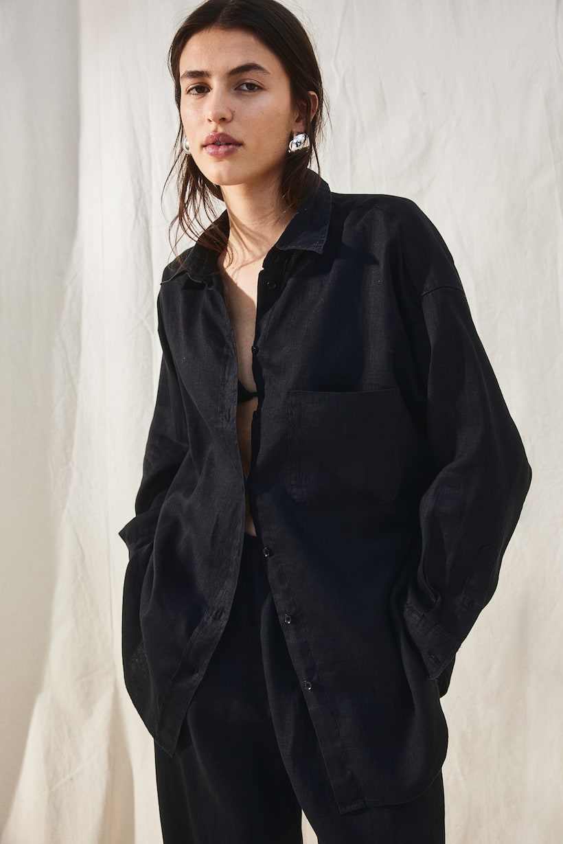 H&M black Oversized shirt in an airy linen weave with a collar, buttons down the front, a patch chest pocket and a double-layered yoke at the back. Dropped shoulders with buttoned cuffs and a sleeve placket with a link button. Rounded hem.