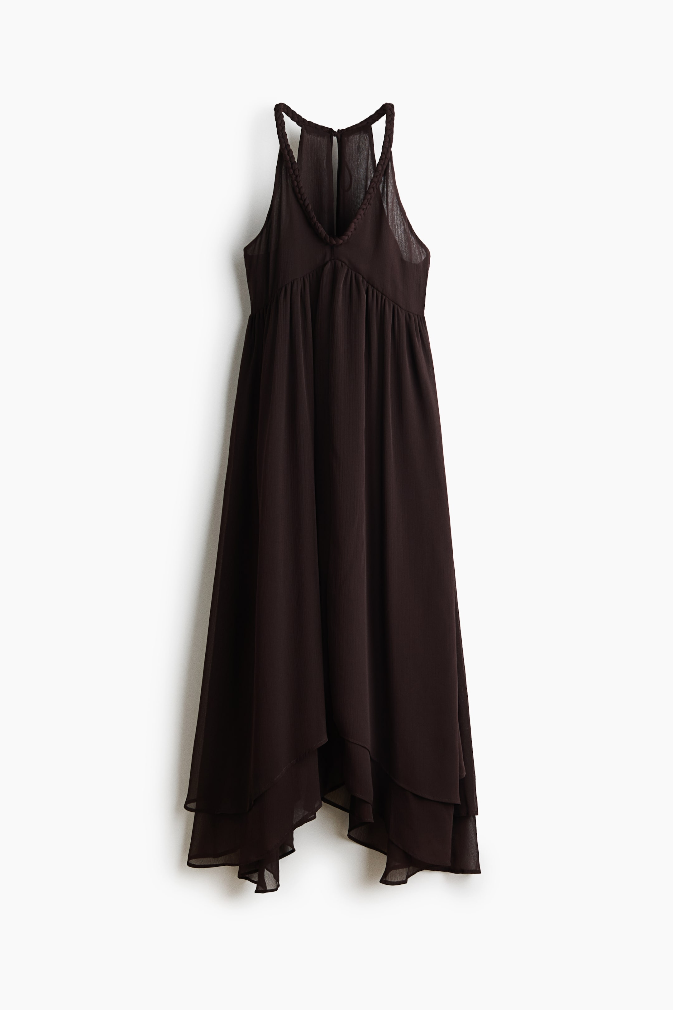View larger image: A deep brown dress is displayed, showcasing braided straps that create a deep V-neckline and a halter design. The gathered bodice transitions into an asymmetrical, layered skirt with a sheer finish, and a subtle keyhole opening can be seen at the upper back.