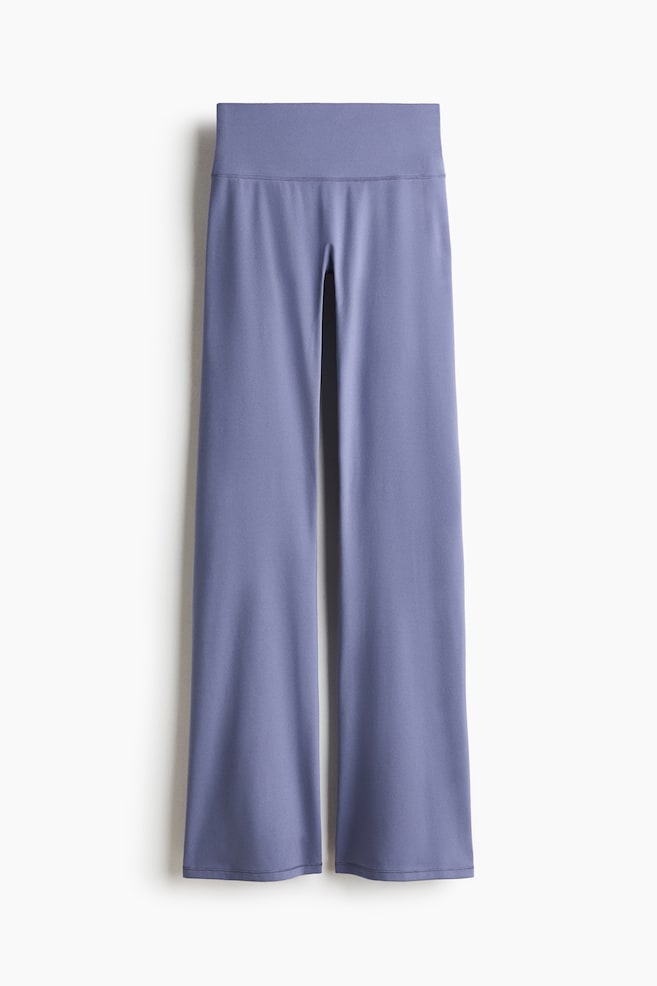 Flared Yoga leggings with SoftMove? are showcased from the front, featuring a wide, high-rise waistband. The smooth, periwinkle-coloured fabric of the legs flares from the thigh to the hem. - 1