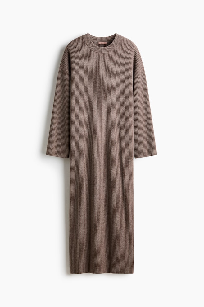 An ankle-length dress in brown rib-knit fabric is hanging facing forwards, featuring a crew neck, low dropped shoulders, and long, wide sleeves. The dress showcases a straight-cut silhouette with a uniform ribbed texture throughout. - 1