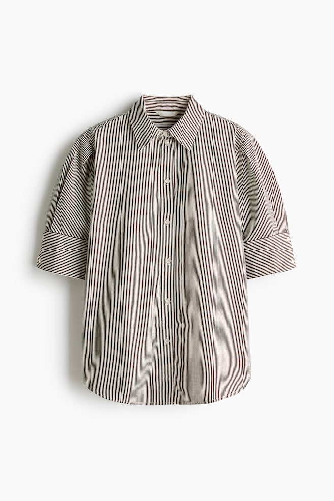 A short-sleeved button-down shirt is shown from the front, featuring a brown and white vertical stripe pattern. The shirt showcases a classic point collar, a central button-down closure, and elbow-length puff sleeves with wide, buttoned cuffs and a curved hem. - 1