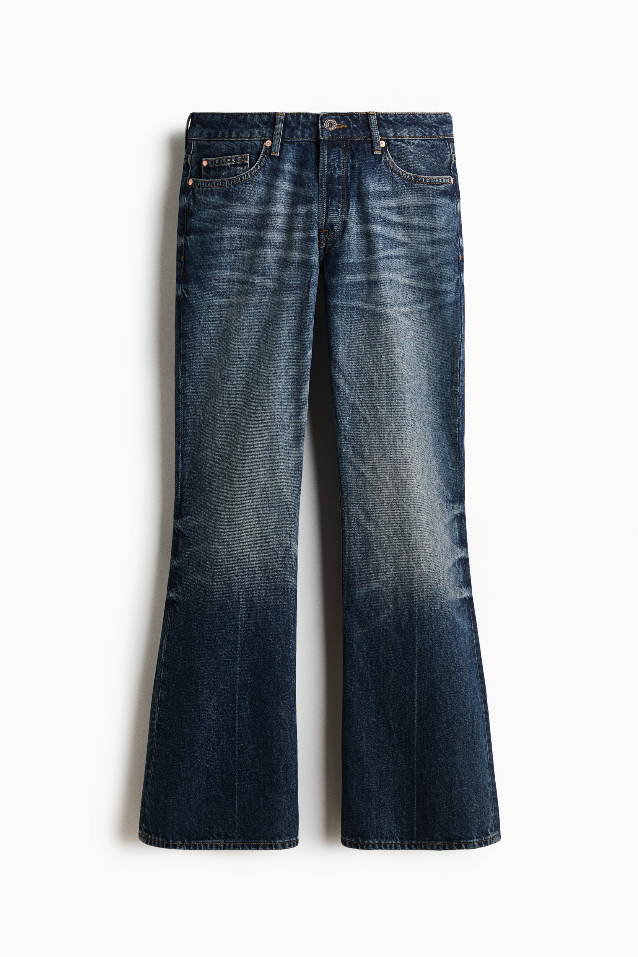 View larger image: These dark blue denim jeans are shown front-facing, featuring a five-pocket design with a regular waist, belt loops, and a button fly. The jeans have a faded wash with whiskering across the thighs and flare from the knees down to the hems.