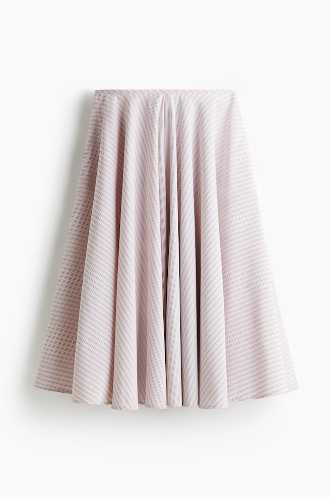 A front view of a flared skirt is displaying a light pink fabric with thin, evenly spaced grey-blue horizontal stripes. The material is draping fluidly, creating soft folds that emphasize the skirt's wide, flowing silhouette. - 1
