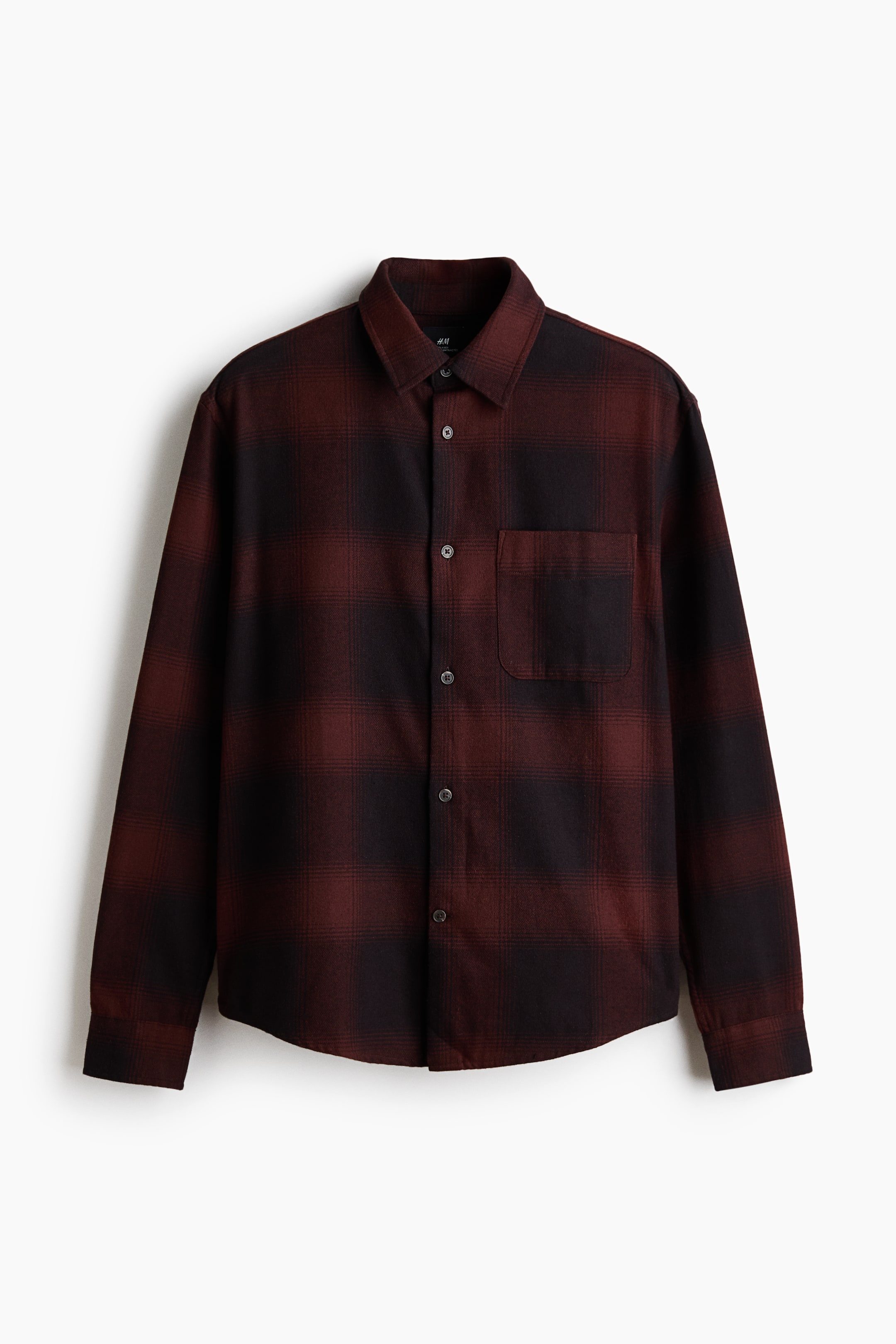 View larger image: A red and black plaid flannel shirt is displayed from the front, featuring a turn-down collar, a French front, and an open chest pocket on the left side. Its long sleeves end in buttoned cuffs with a sleeve placket, while a gently rounded hem finishes the bottom, and the shirt showcases a loose fit.