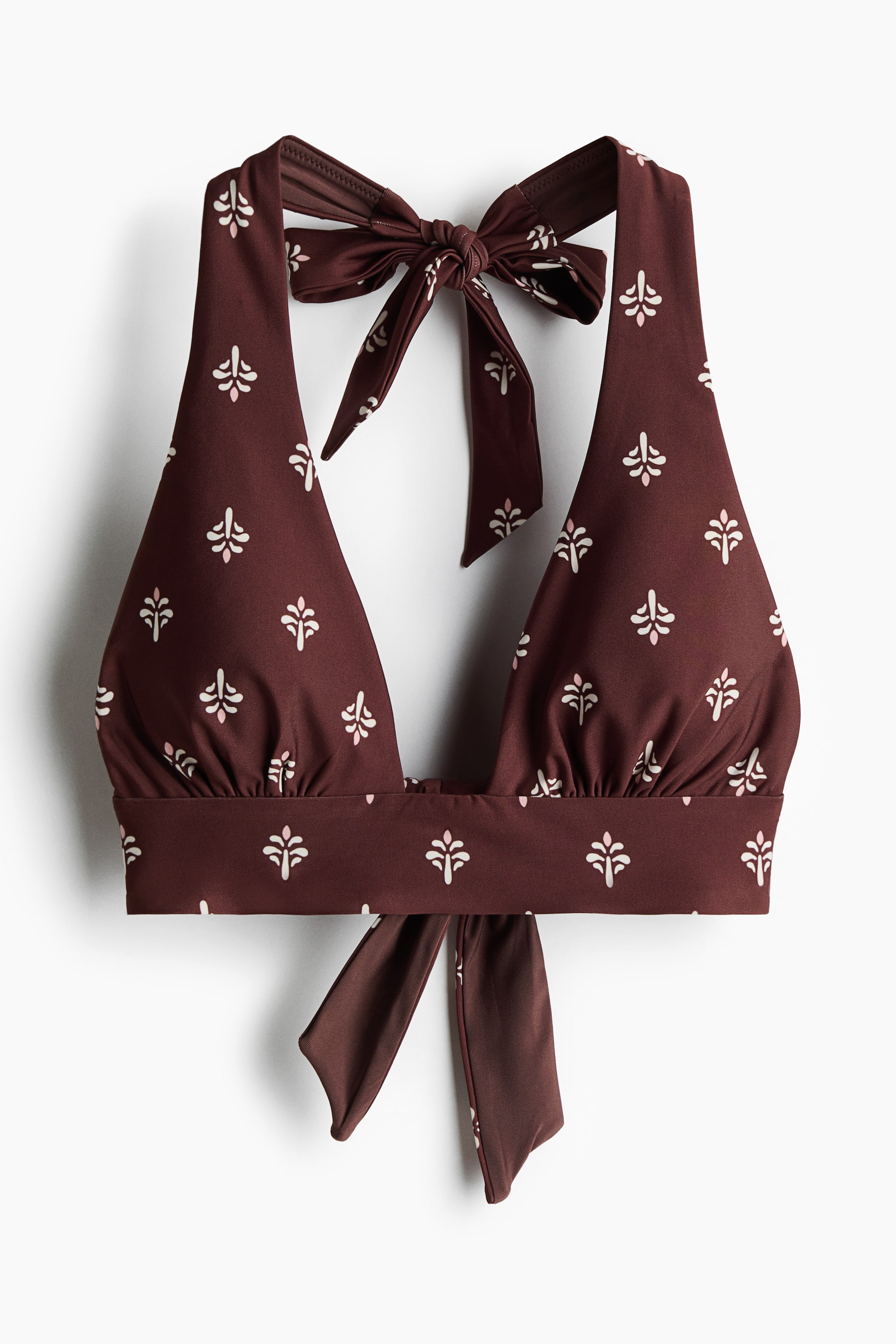 View larger image: The bikini top, shown from the FRONT, features a dark brown hue with an off-white and pink pattern. It showcases a V-neckline, gathered cups, wide halterneck ties that tie into a bow at the top, a wide trim at the hem, and wide ties that fasten at the back.