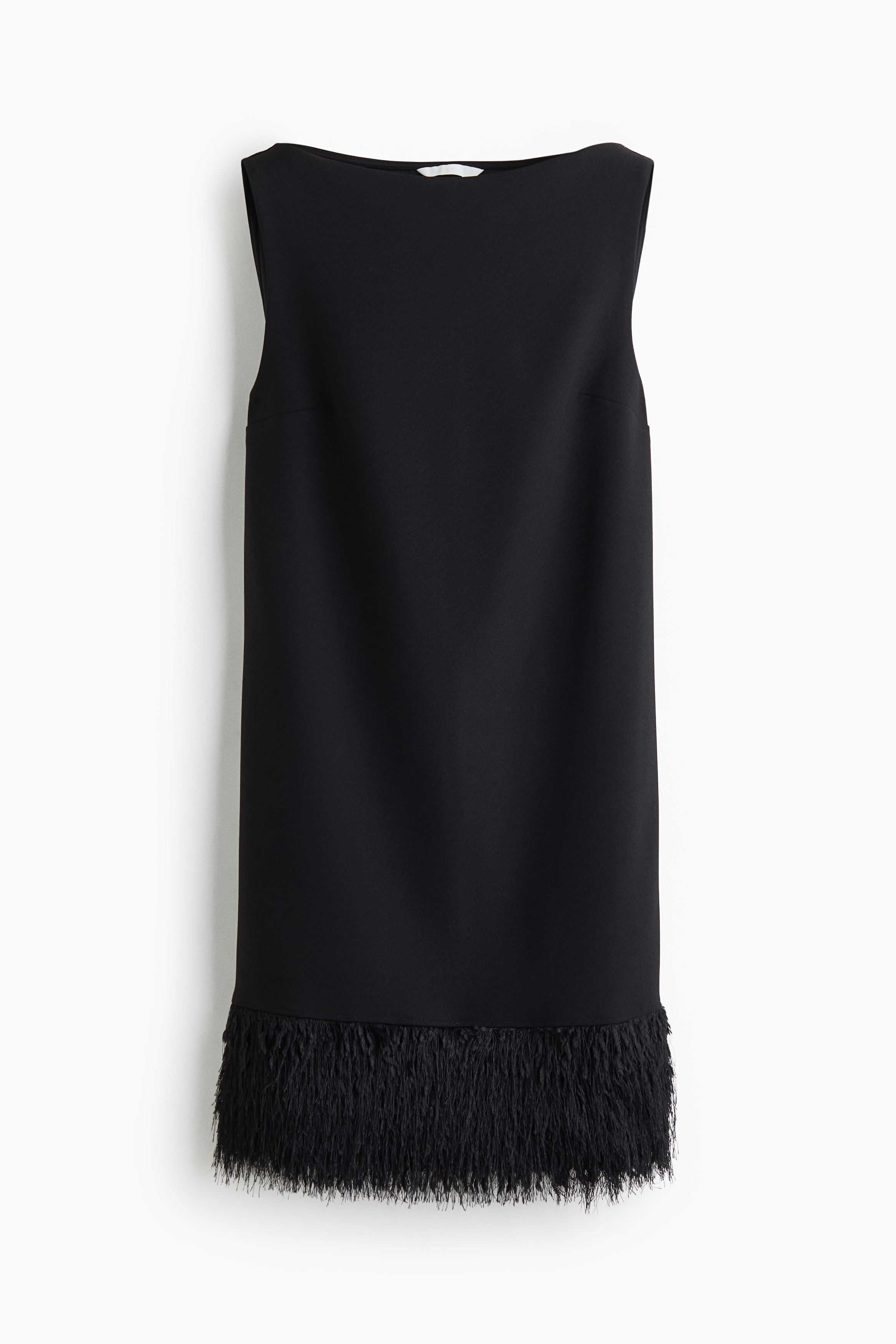 A black sleeveless mini dress featuring a wide boat neck and a textured fringed hem is being worn by the model.