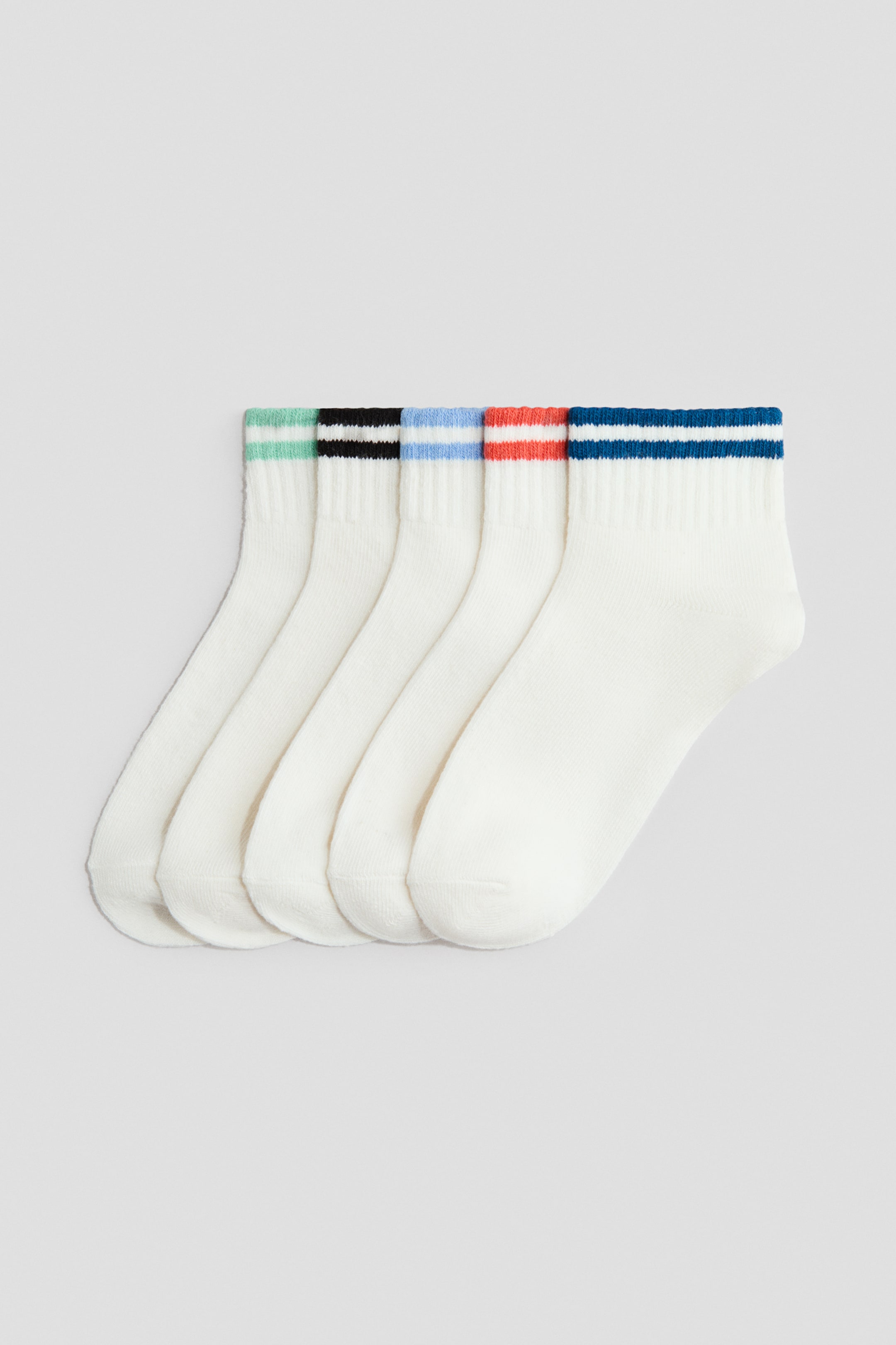 View larger image: Five ankle socks are neatly arranged flat, showcasing their front views. Each sock boasts an off-white, fine-knit body with ribbed cuffs, embellished with two horizontal stripes in a variety of colours, including light green, black, light blue, orange, and dark blue.