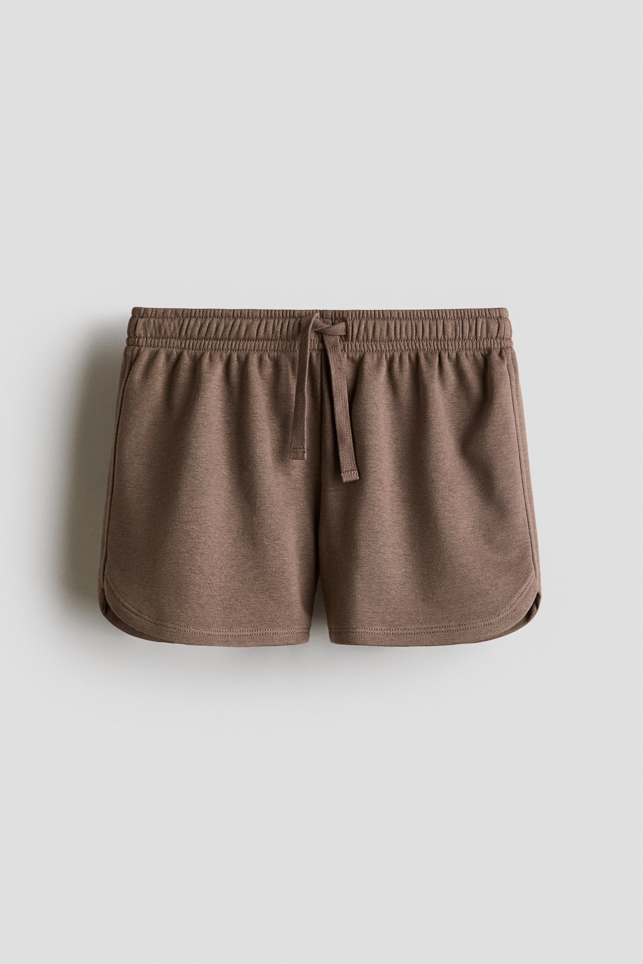 View larger image: "The relaxed-fit shorts are displayed from the front, showcasing an elasticated, drawstring waist with the drawstring neatly knotted. These shorts feature a lightweight, heathered brown sweatshirt fabric and exhibit curved hems."