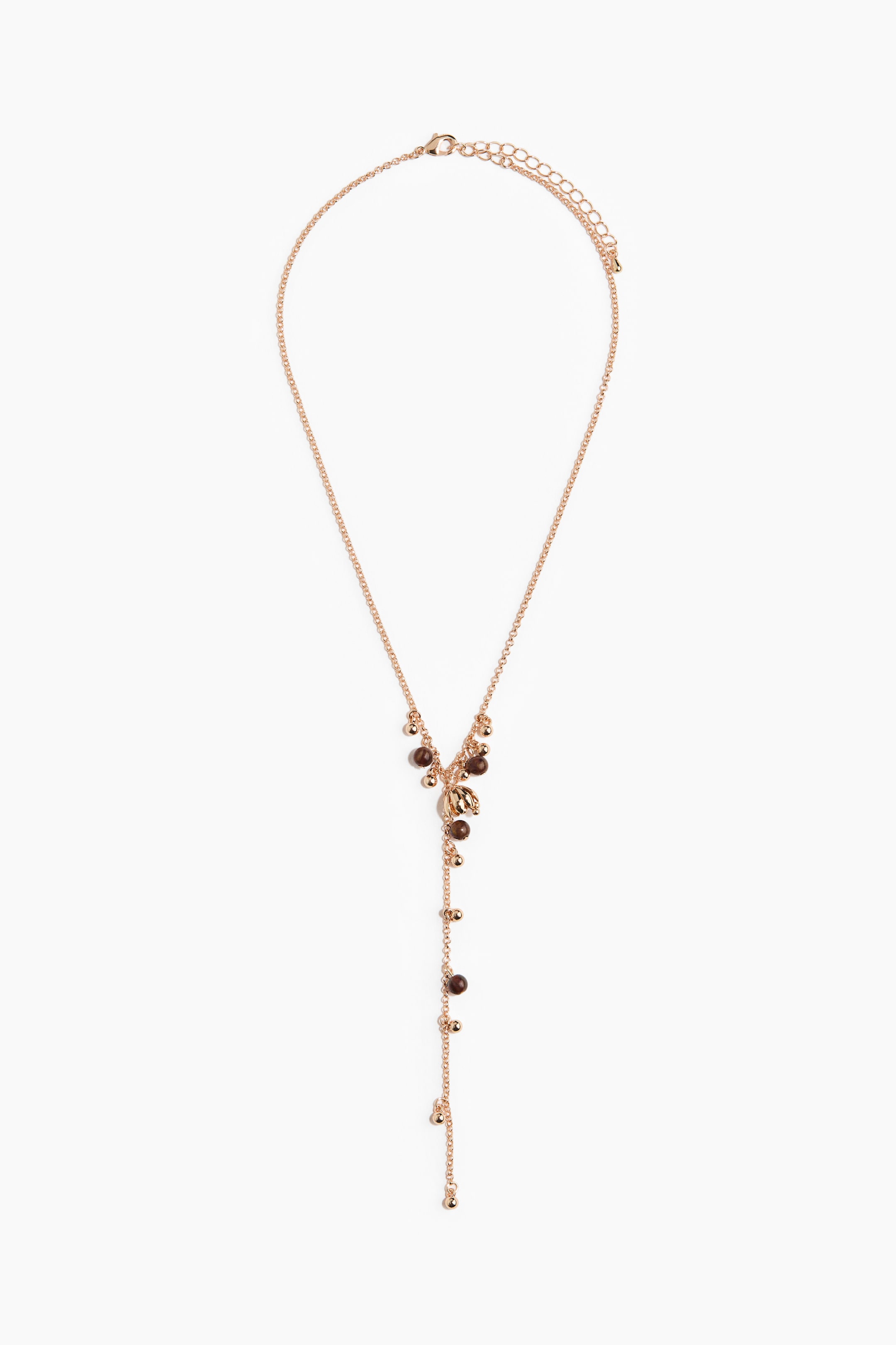 Grotere afbeelding bekijken: Een roségoudkleurige lariat-ketting wordt van voren getoond. Ze heeft een Y-vormig ontwerp met kleine bruine en goudkleurige kraaltjes bij de Y-verbinding en extra kleine goudkleurige kraaltjes langs de hangende ketting. Aan de achterkant zijn een karabijnsluiting en een verlengketting zichtbaar.