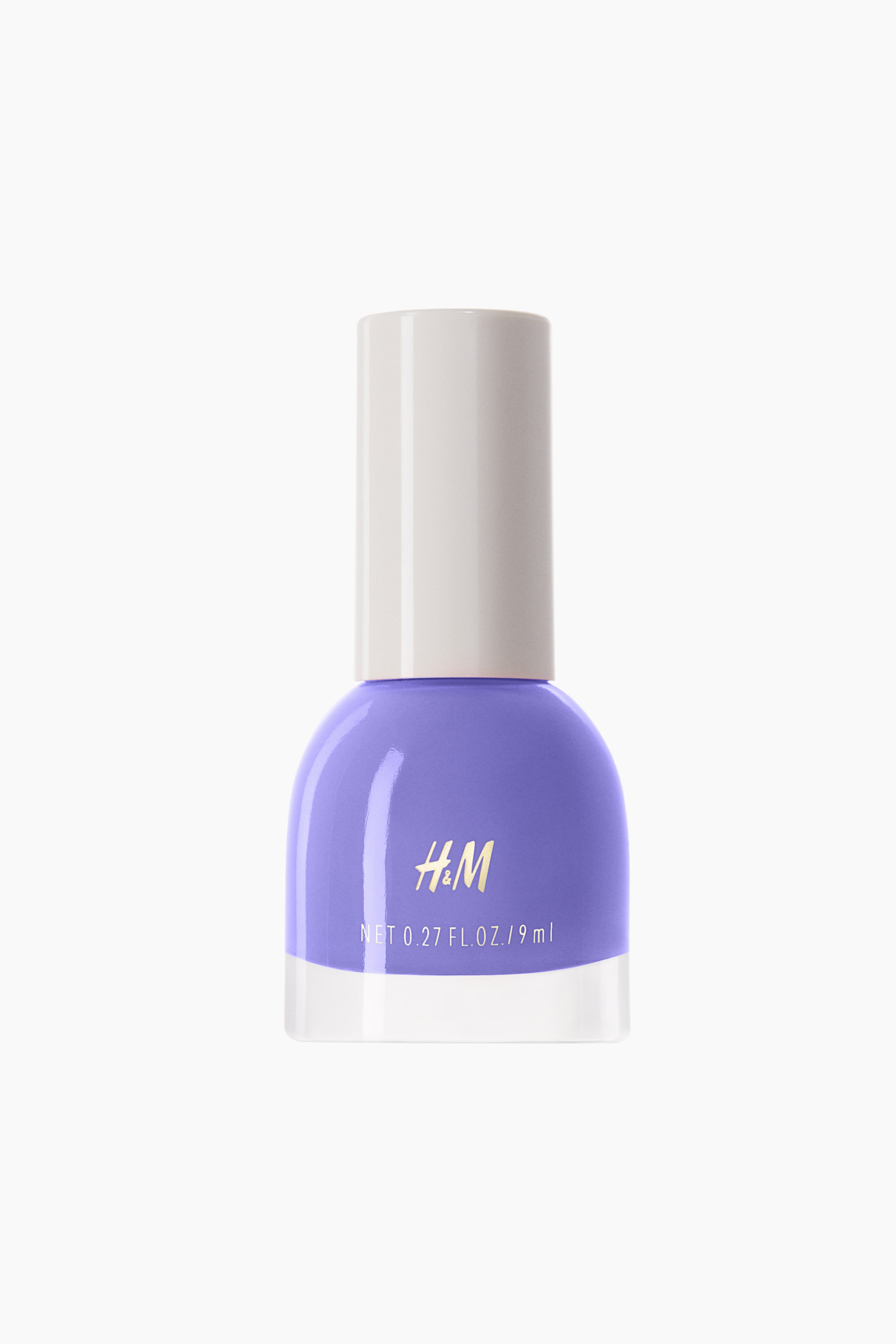 View larger image: The nail polish bottle, in a subtle shade of light purple, stands upright with its front facing forward. It boasts a rounded clear glass base and is topped with a cylindrical off-white cap. The brand "H&M" is elegantly displayed in gold text, accompanied by "NET 0.27 FL. OZ. / 9 ml" in white text on the front.