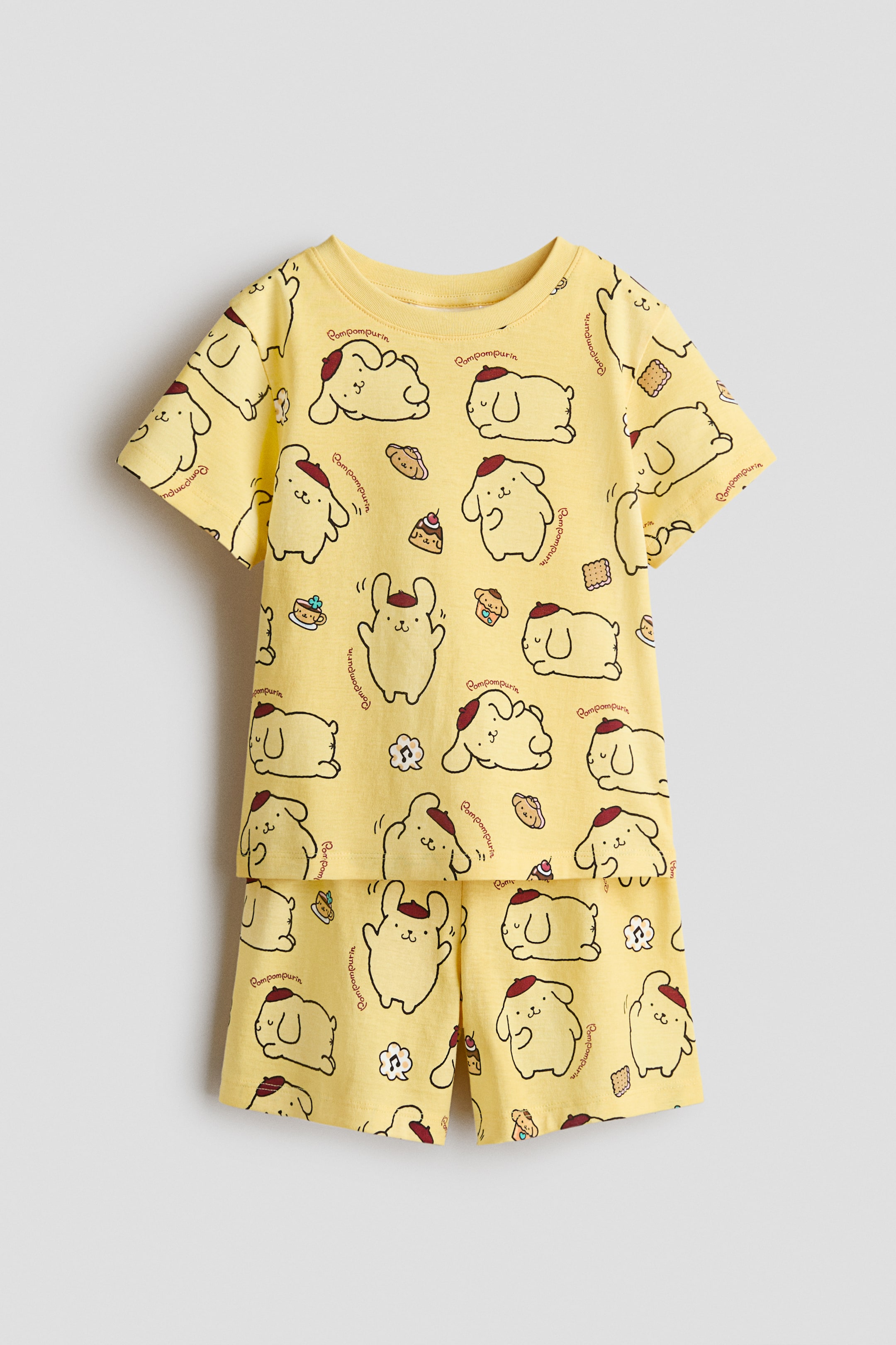 View larger image: Pyjamas comprising a T-shirt and shorts are displayed front-facing, made from yellow printed cotton jersey with Pompompurin characters and sweets. The T-shirt features a round, rib-trimmed neckline and a straight-cut hem, while the shorts come with an elasticated waist.