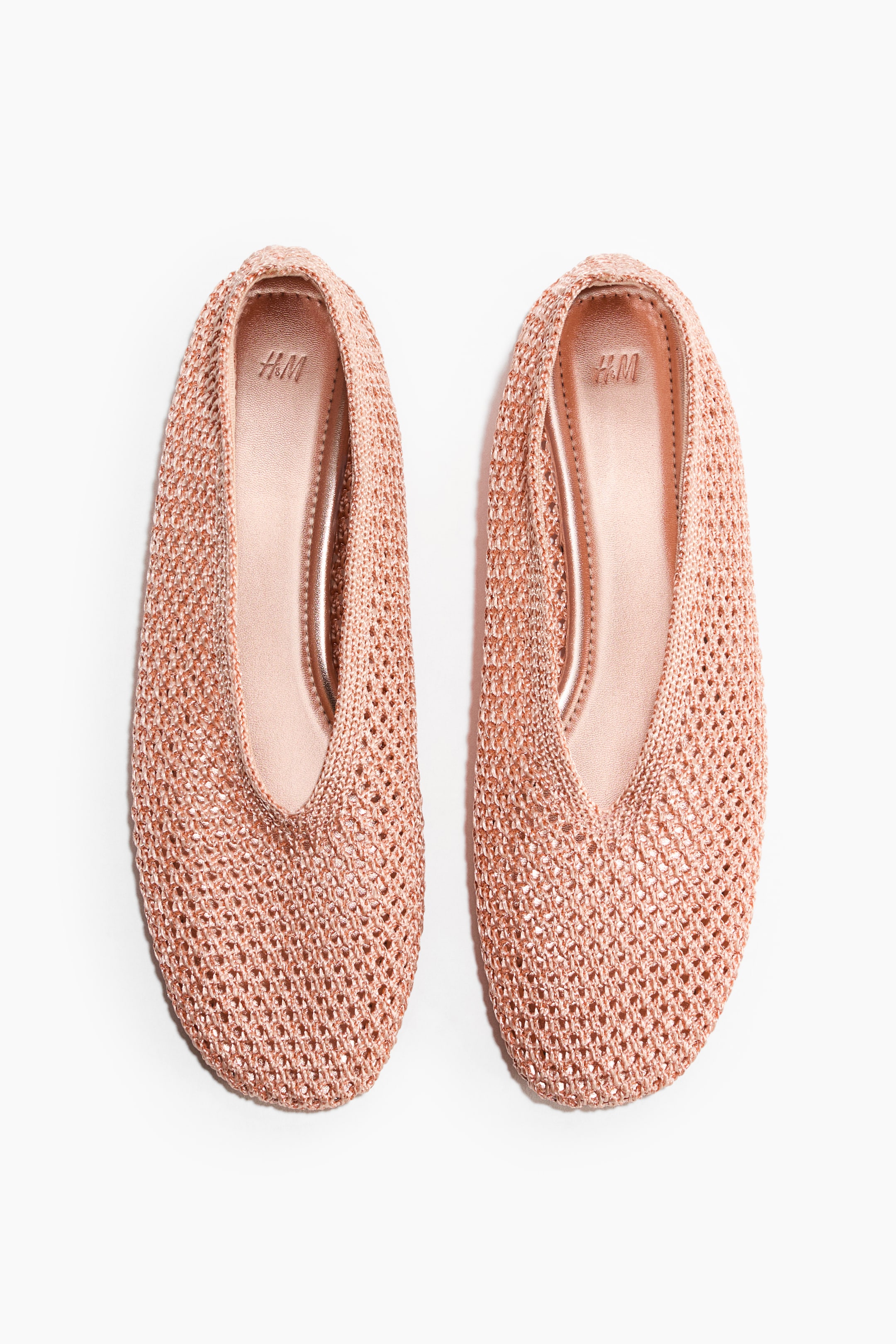 Grotere afbeelding bekijken: Ballerina's van gevlochten kunststof stro met afgeronde neuzen tonen een metallic roségouden afwerking en een opengewerkte constructie. De zichtbare binnenzolen zijn in bijpassend metallic roségoud, met 'H&M' in reliëf nabij de hiel.