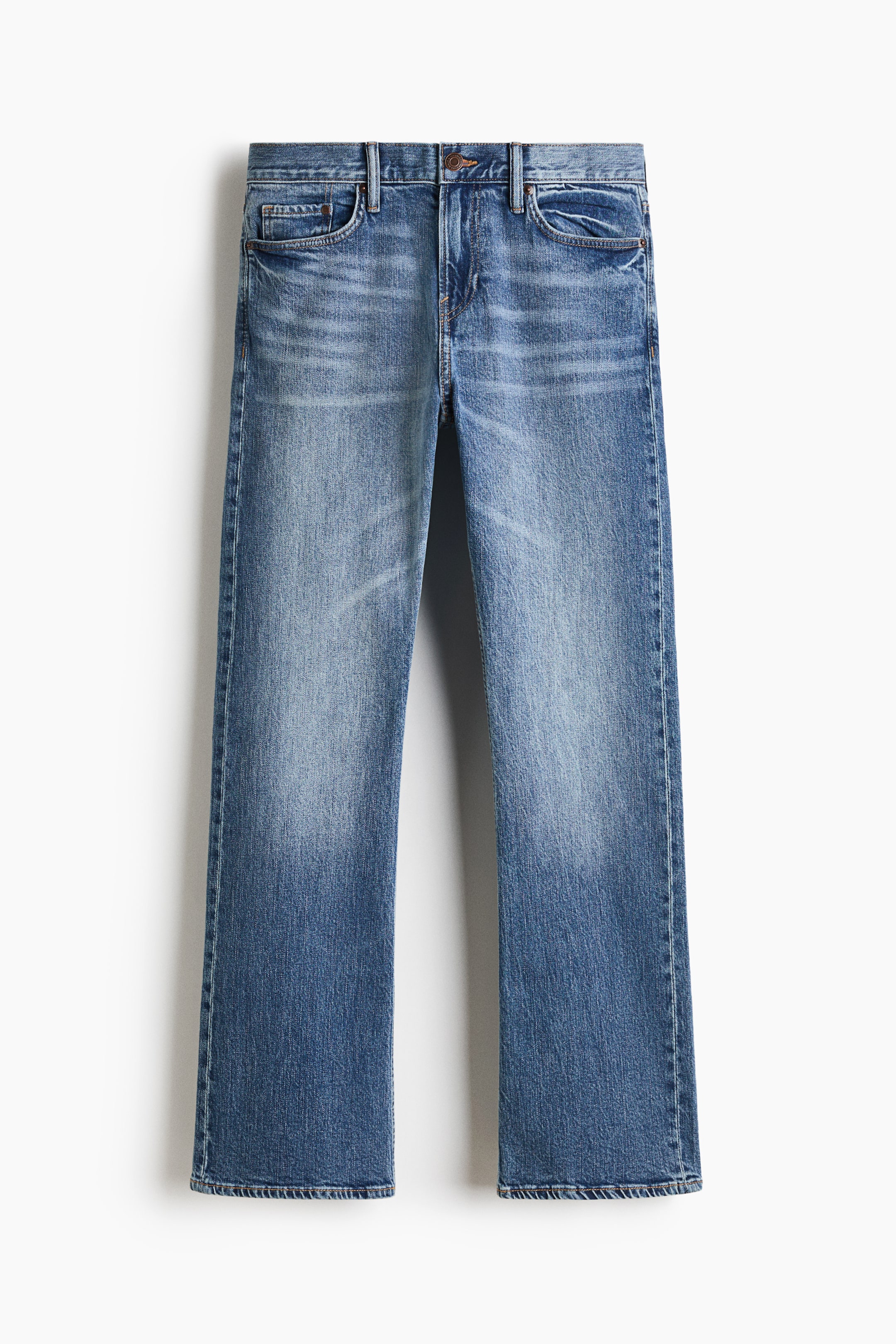 View larger image: A pair of straight-leg blue jeans is shown from the front, featuring a medium-blue wash with noticeable fading along the thighs and knees, along with whiskering at the hips. The jeans have classic five-pocket styling, belt loops, and a button closure.
