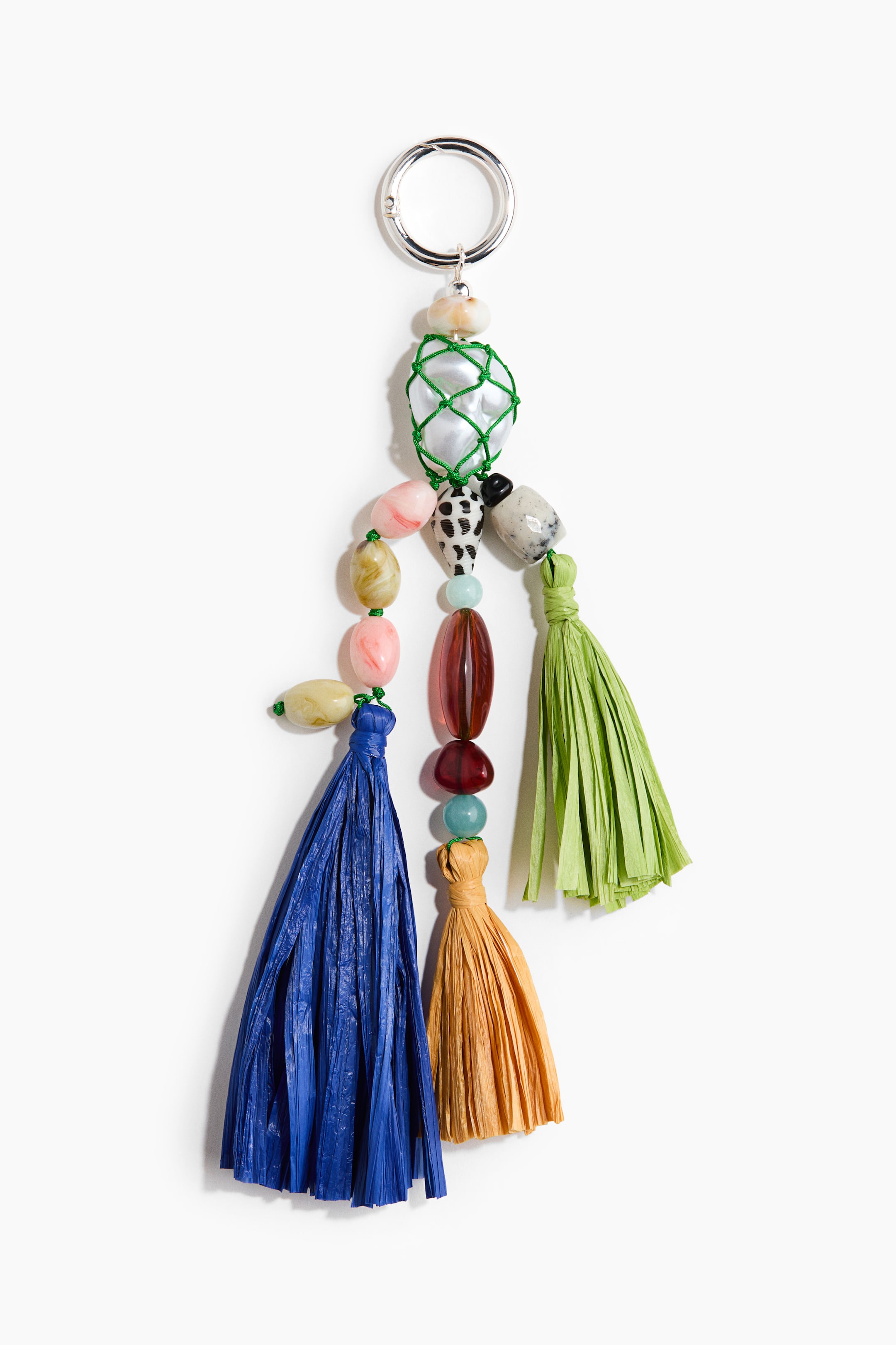 View larger image: A beaded keyring featuring a silver-tone ring at the top, from which a large white pearl encased in green netting hangs. It also showcases various irregular and oval-shaped beads in shades of pink, green, blue, black, and red. Additionally, three raffia-like tassels in royal blue, golden brown, and lime green dangle from the bottom.