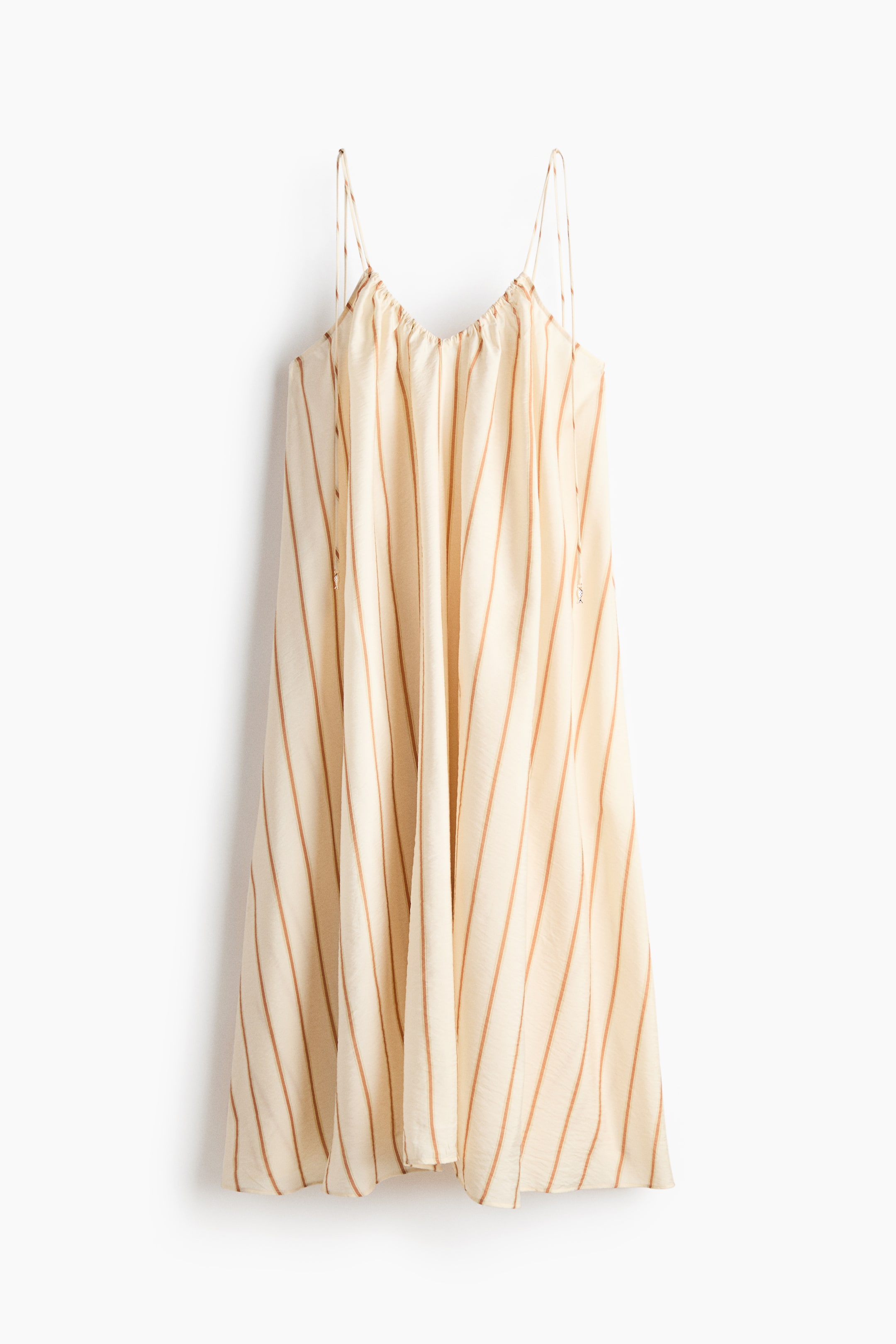 View larger image: "A cream-coloured dress with brown vertical stripes is showcased from the front. It features thin spaghetti straps and a gathered V-neckline, flowing in a relaxed silhouette."