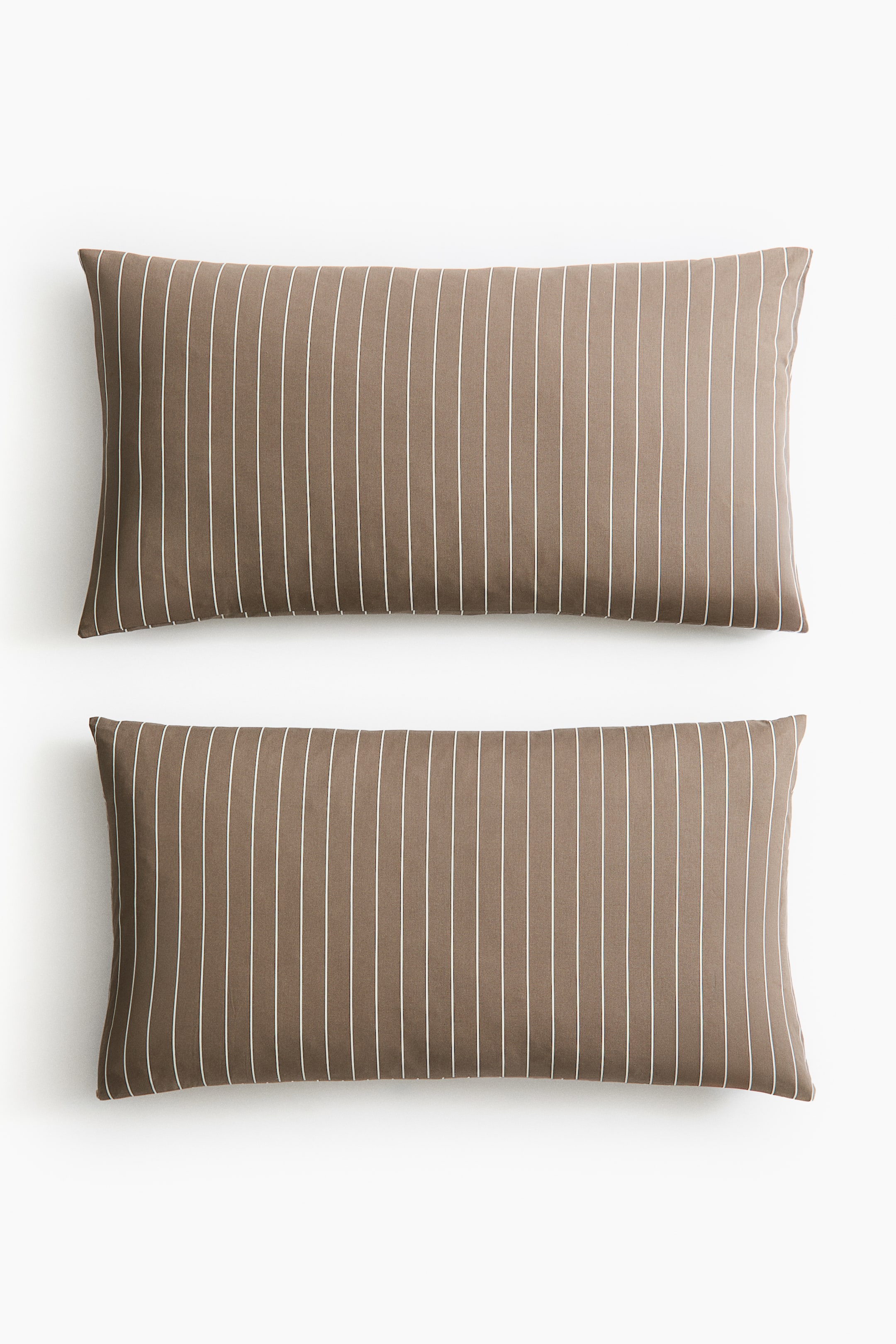 View larger image: Two pillowcases are displaying their front sides, featuring a soft cotton weave with a brown base and thin white vertical stripes. Each pillowcase is designed with an envelope opening.