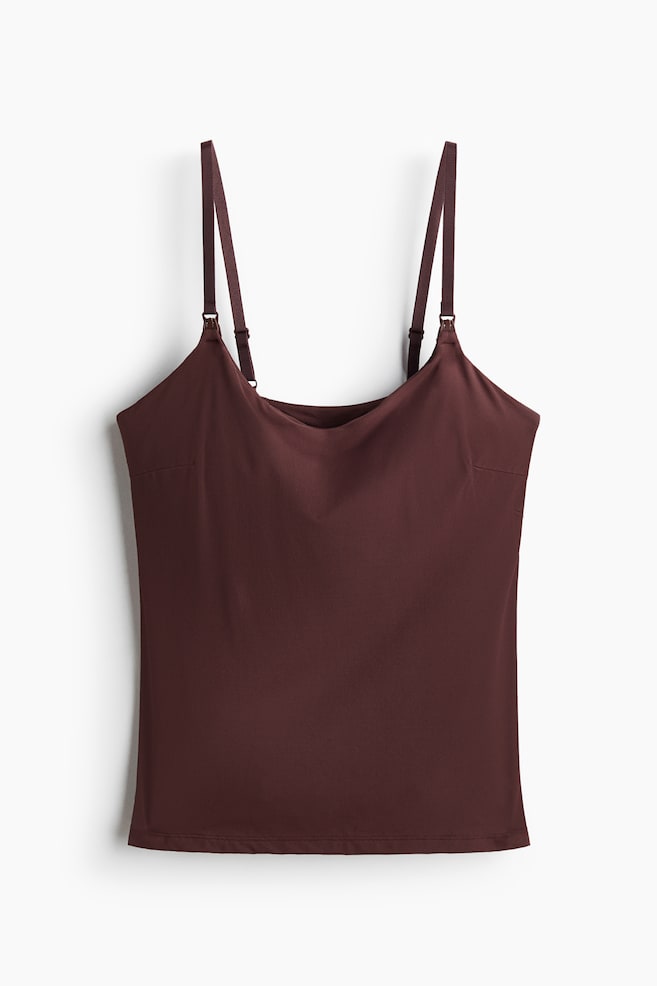 A dark brown nursing top in soft microfibre is presented front-facing. It features narrow, adjustable shoulder straps with nursing clasps, and a smooth, integrated bust section. - 1