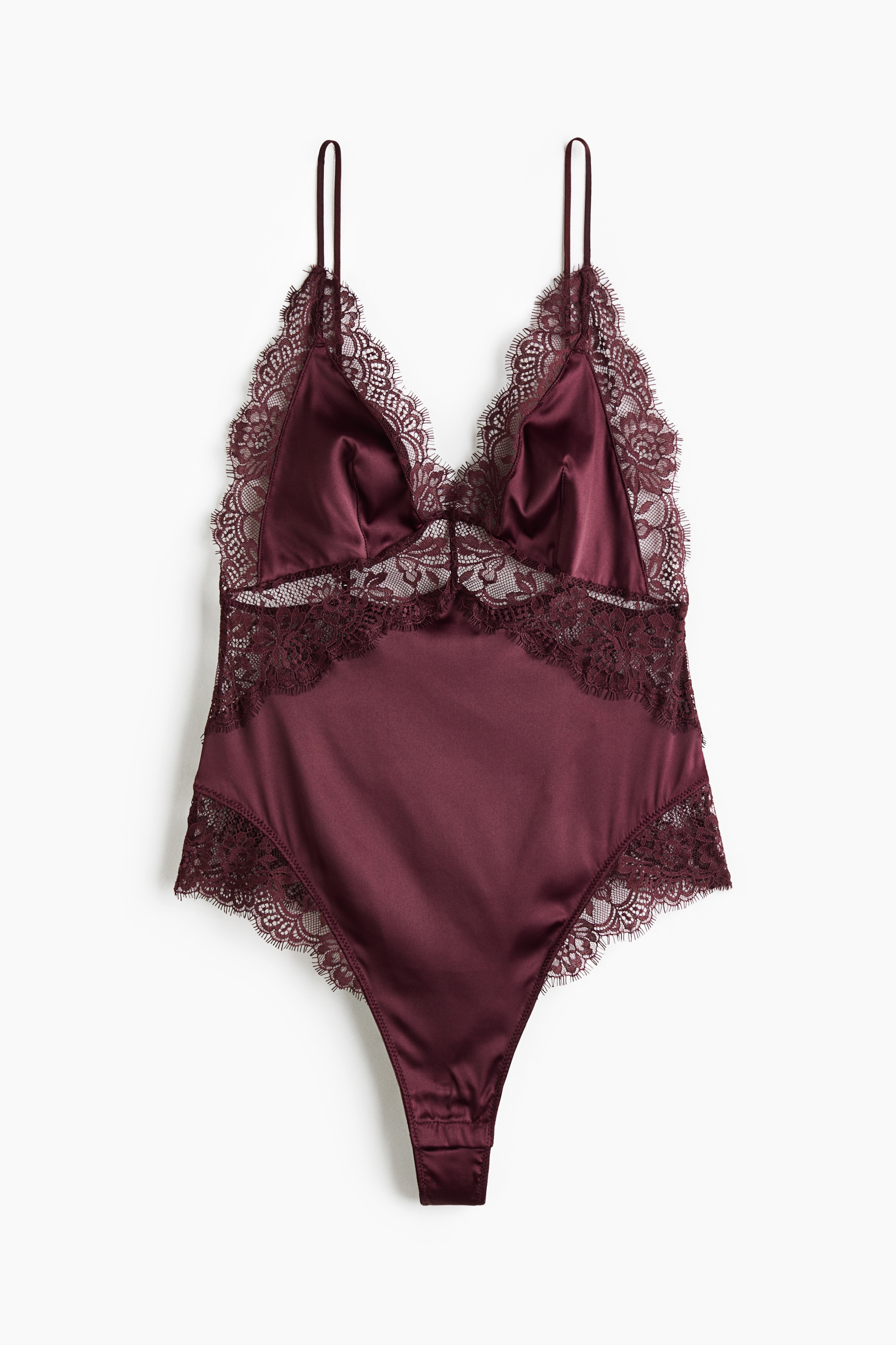 A dark red lace bodysuit with a V-neck and thin shoulder straps is being worn by the model. The bodysuit features sheer floral lace detailing and high-cut leg openings.