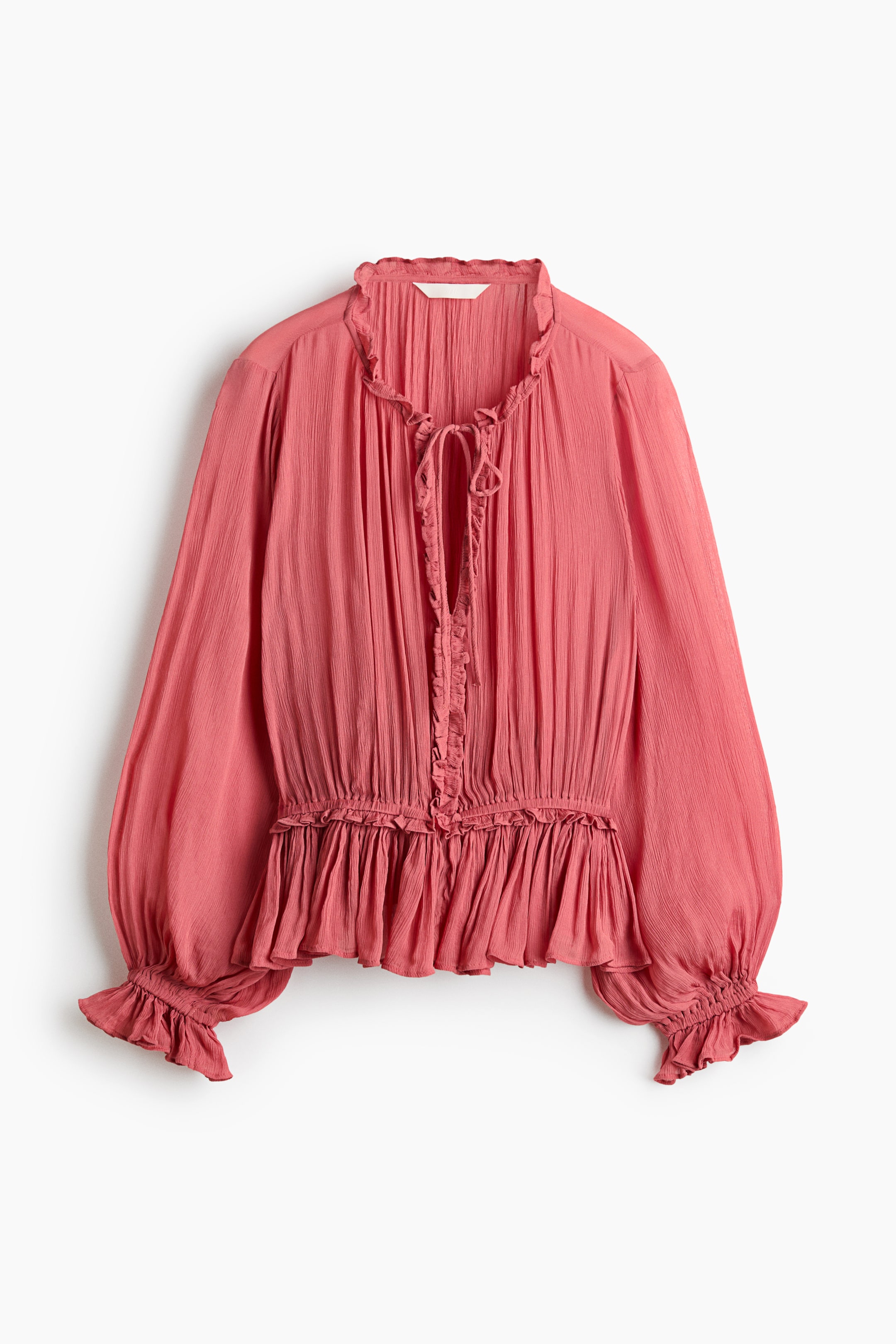 View larger image: A pink crinkled blouse is showcased front-facing, boasting a ruffled high neck with tie-front strings and a ruffled placket, long voluminous sleeves with ruffled elasticated cuffs, and a gathered blouson waist leading to a flared peplum hem.