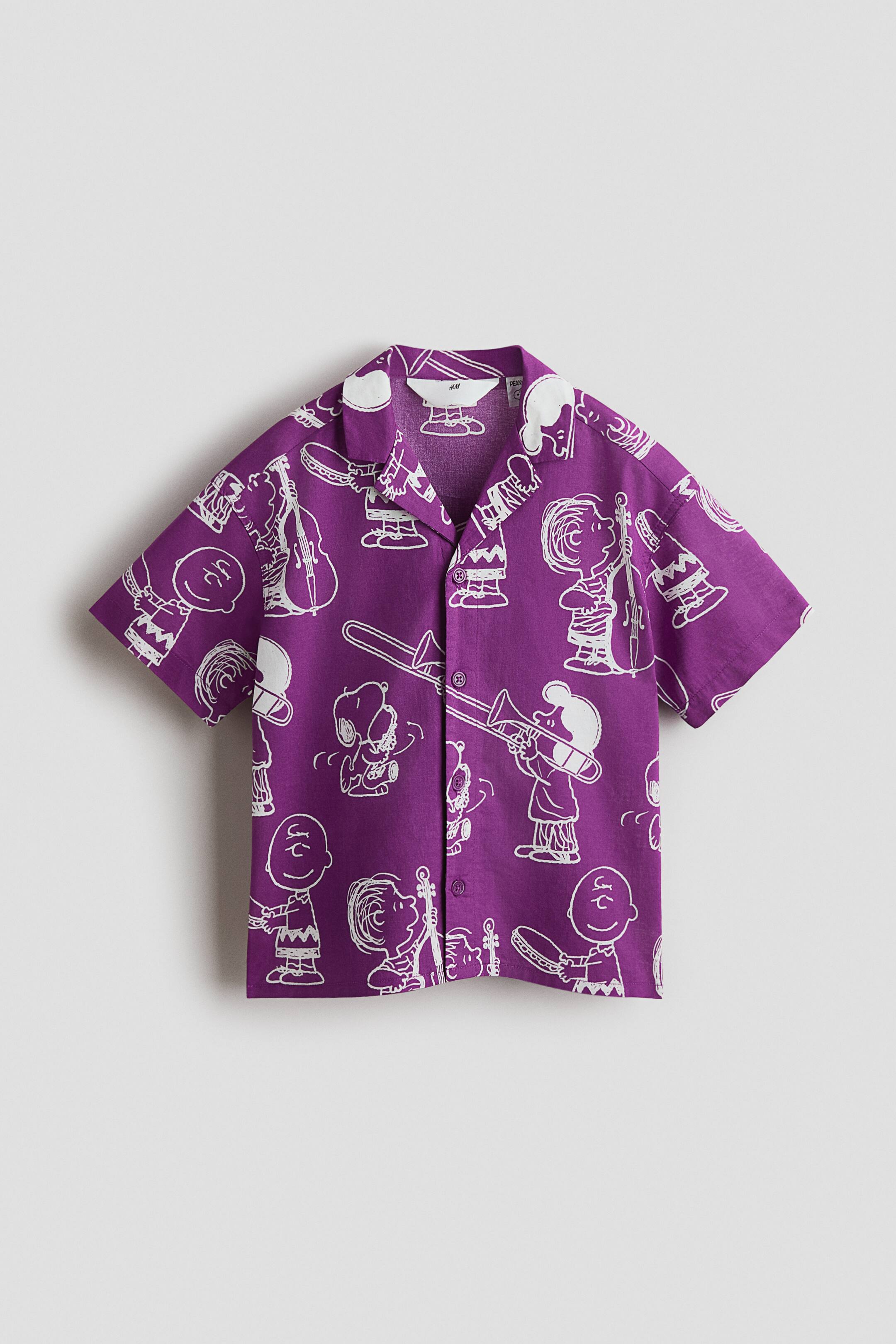 View larger image: The FRONT of the shirt is featuring a revere collar and a button-front closure.