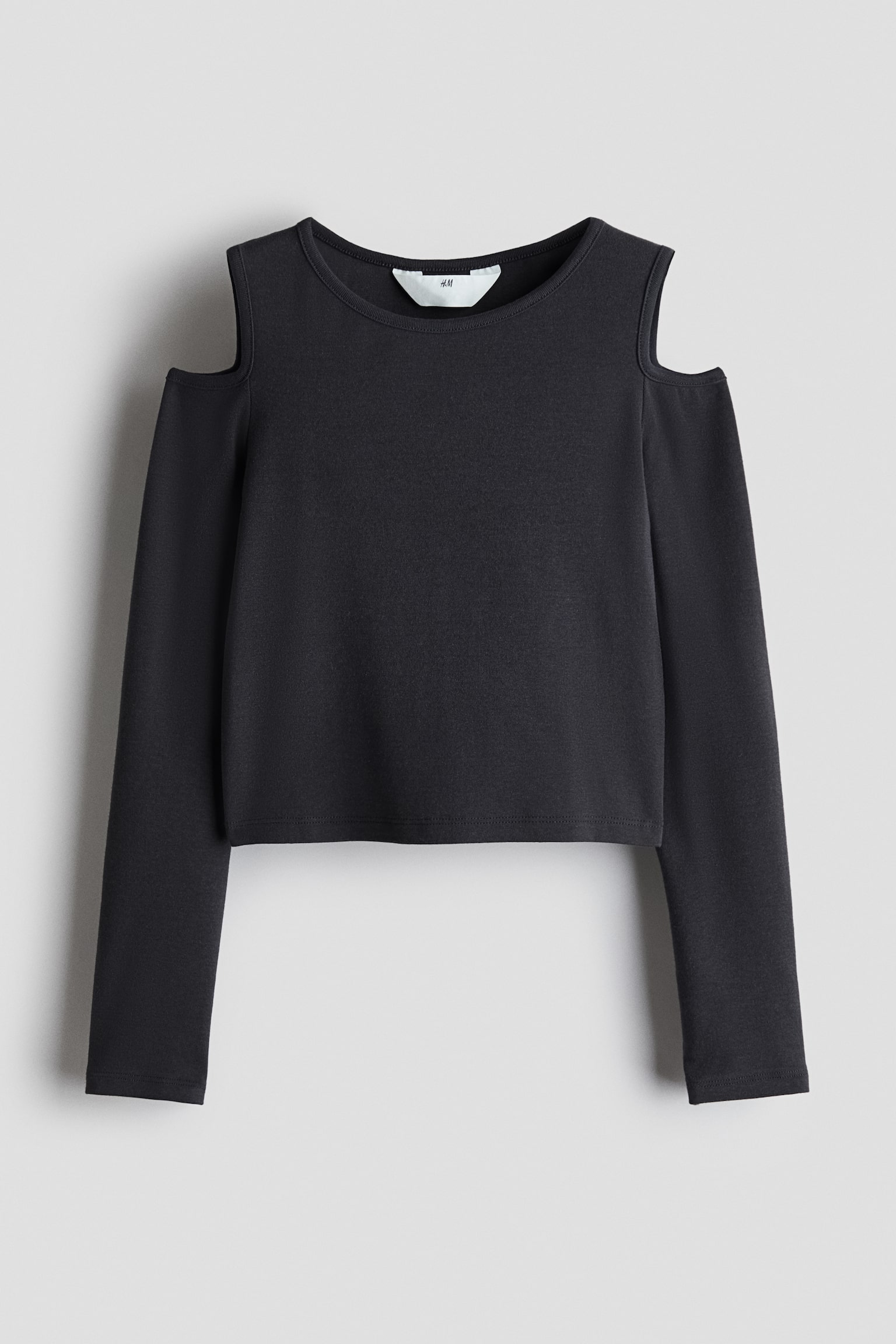 A black long-sleeved top is shown from the front, featuring cold-shoulder cut-outs, a crew neck, and a slightly cropped, straight hem.