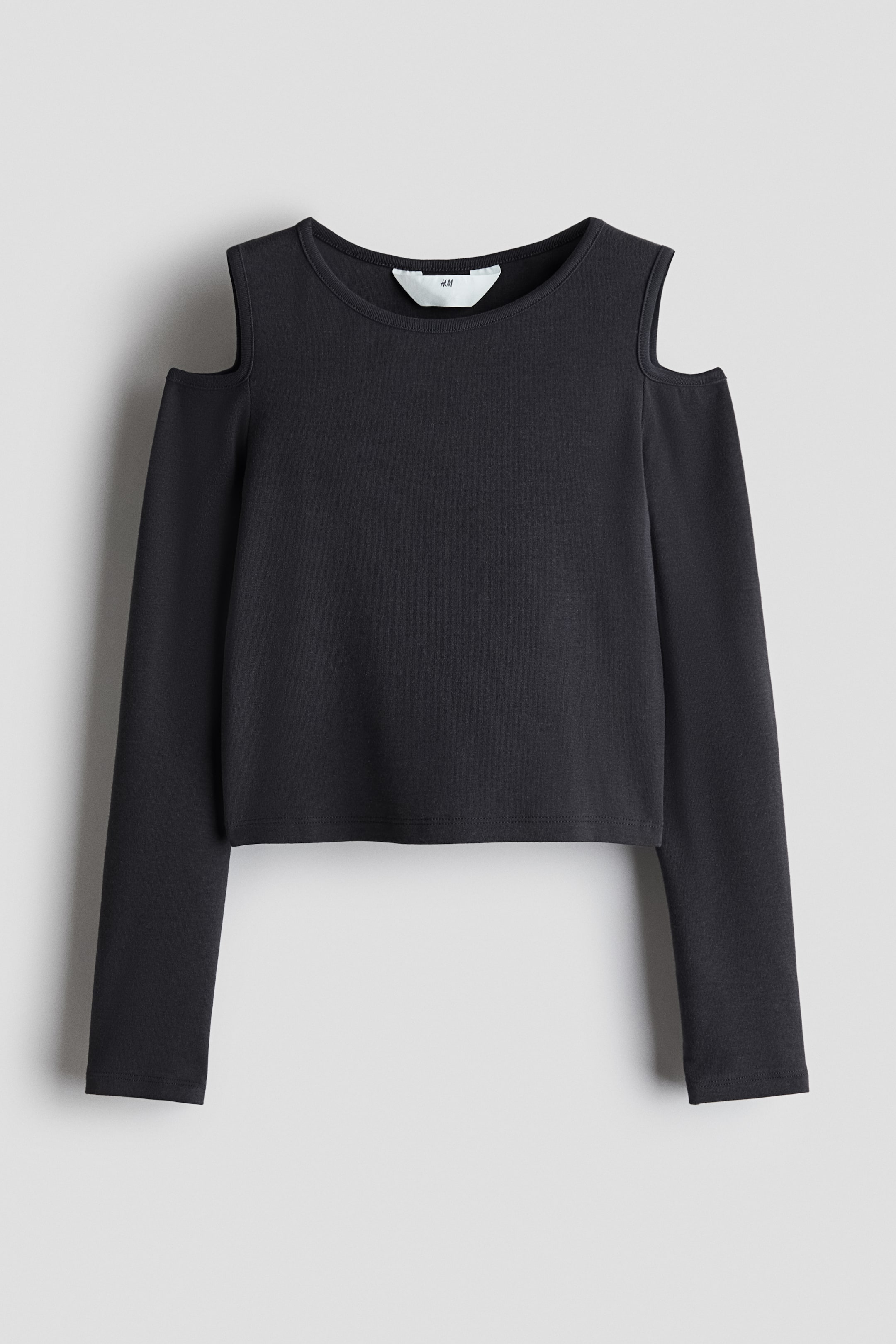 View larger image: A black long-sleeved top is shown from the front, featuring cold-shoulder cut-outs, a crew neck, and a slightly cropped, straight hem.