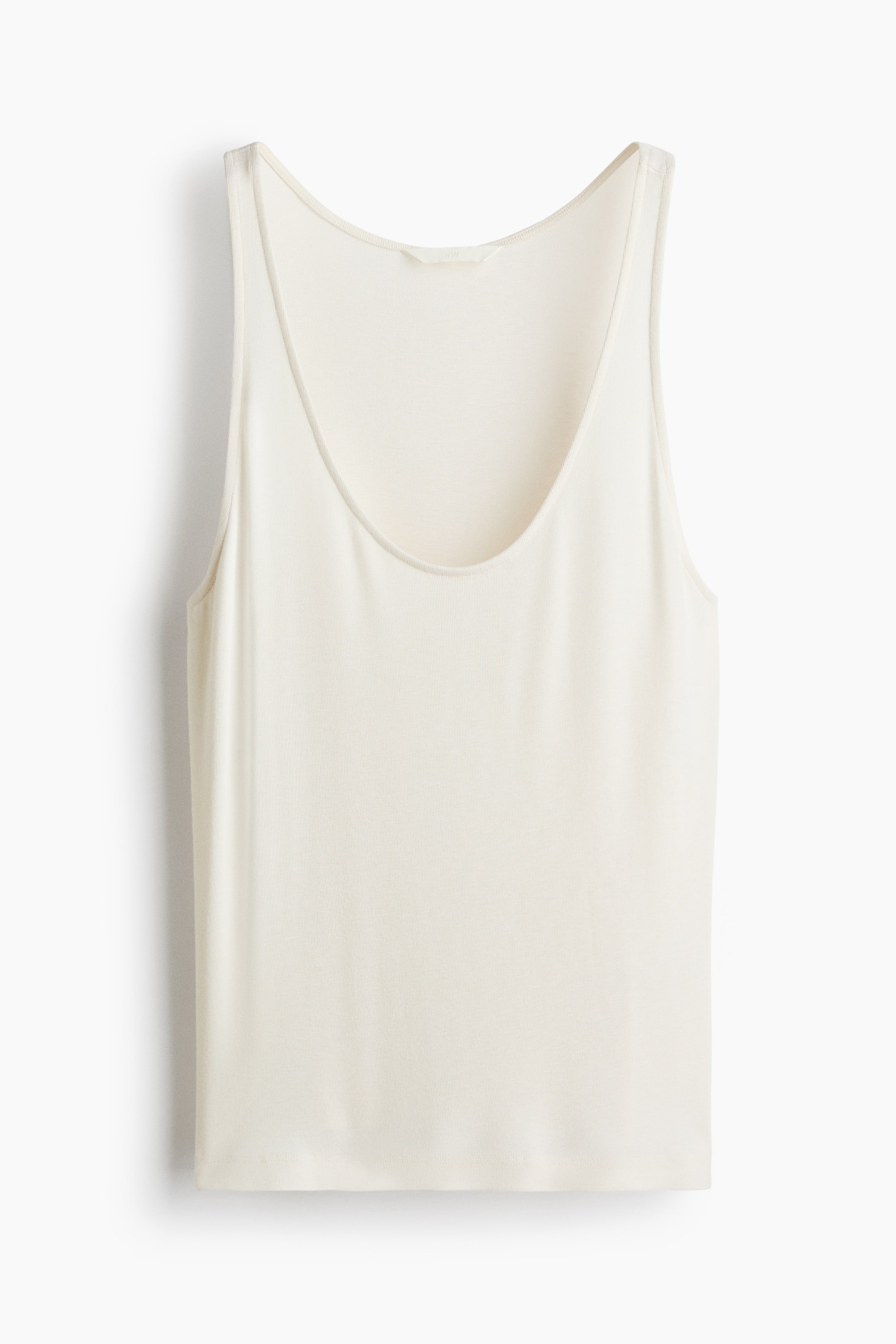 View larger image: A cream-coloured tank top is facing front, featuring a scoop neckline, narrow shoulder straps, and a straight hem. It is displaying a smooth, slightly lustrous fabric.