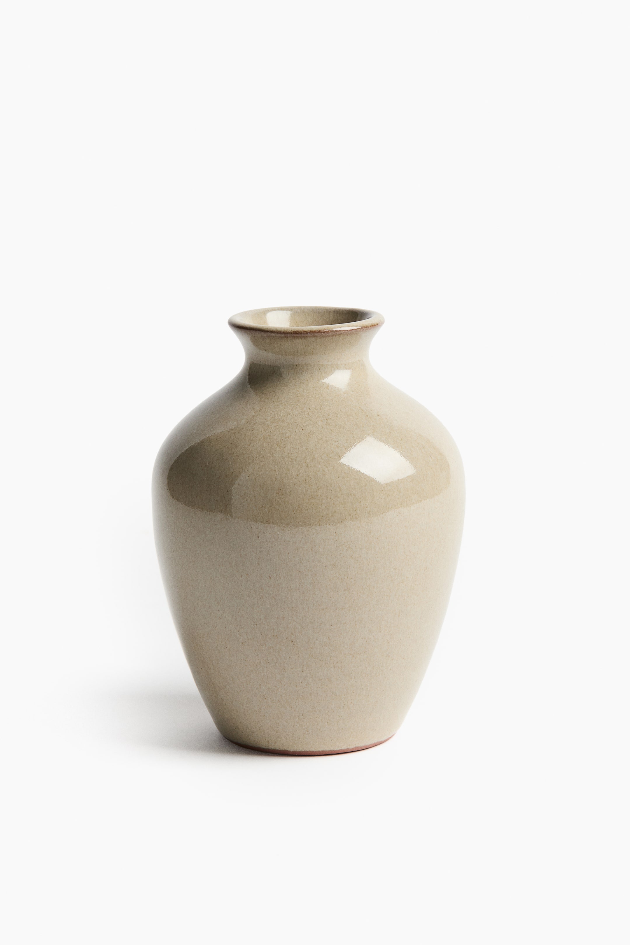 View larger image: A light beige vase showcasing a rounded, tapering body with a flared neck, featuring a matte finish on its lower section and a glossy, reflective glaze on its upper section, complemented by a thin brown rim and base edge.