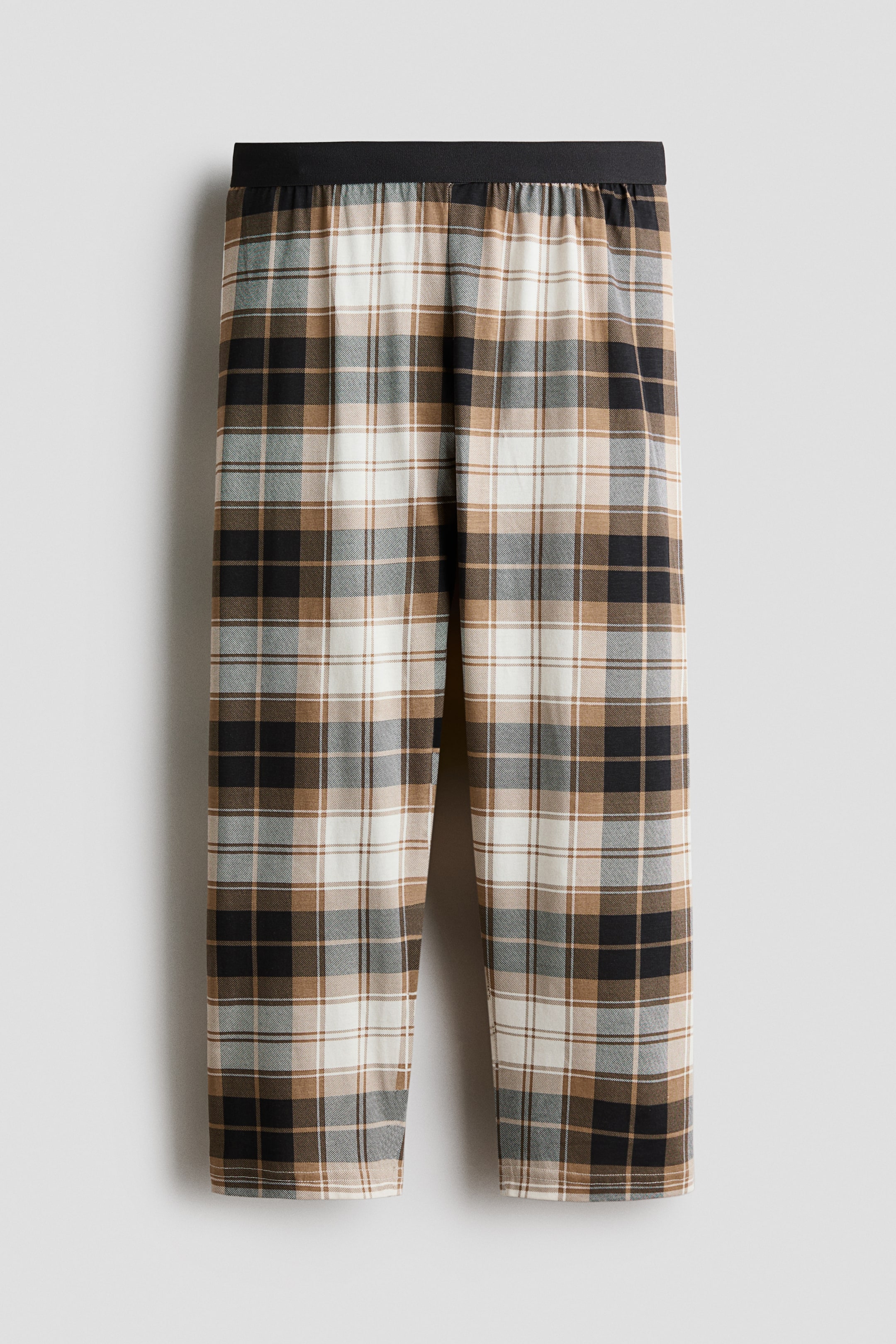 View larger image: Pyjama bottoms crafted from soft cotton jersey, featuring an elasticated waistband, showcase a plaid pattern in shades of black, brown, white, and grey.