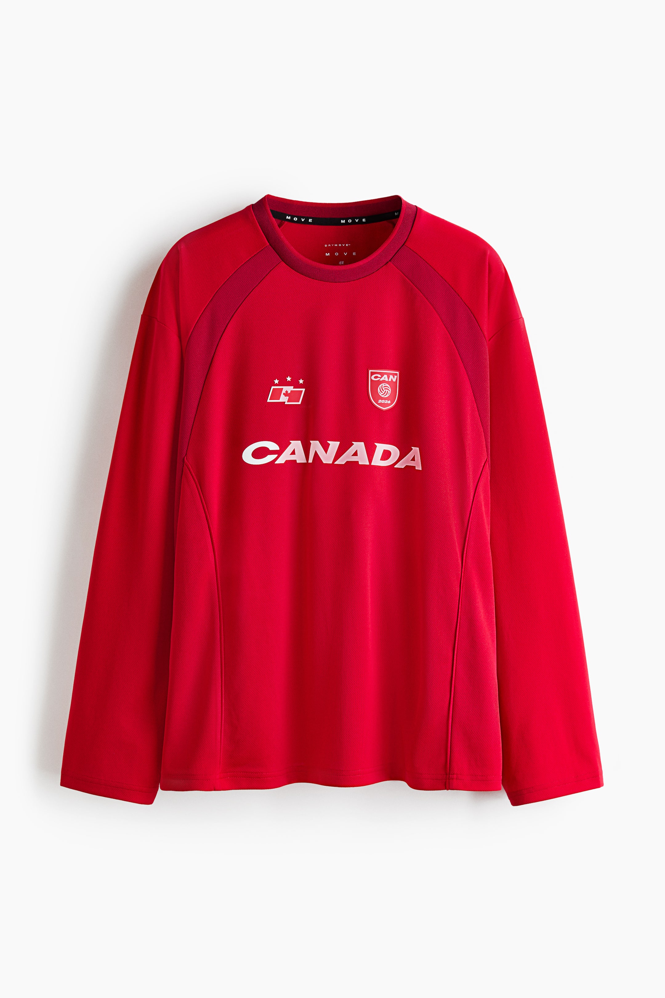 View larger image: The red long-sleeved shirt is showcased from the front, featuring a round neck and raglan sleeves with darker red textured panels. The word "CANADA" is prominently displayed in white across the chest, flanked by a white logo with three stars on the left and a circular "CAN 2024" badge on the right.