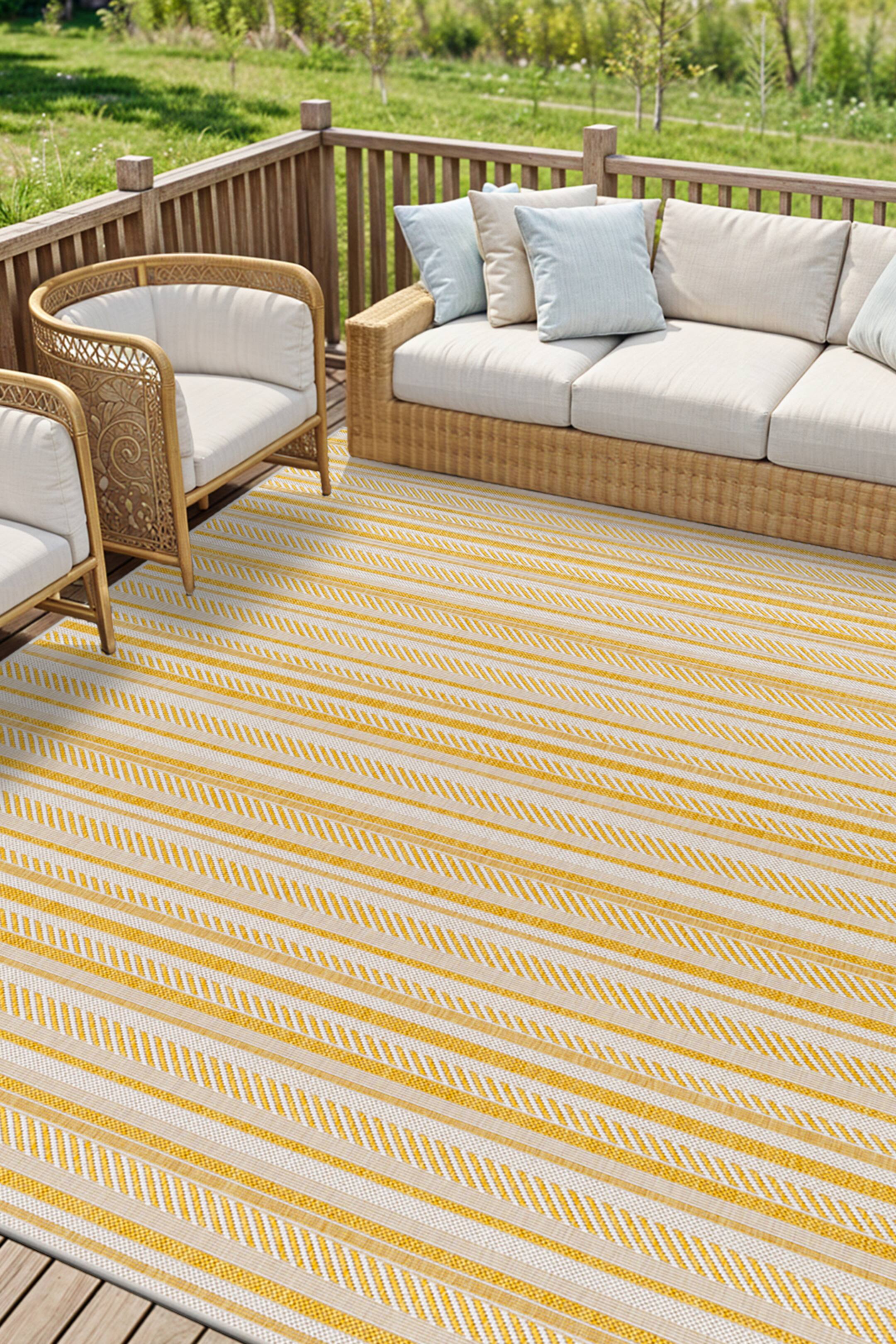 View larger image: A rectangular rug showcases a pattern of yellow and off-white horizontal stripes. The stripes vary in width, featuring solid yellow bands and yellow and white chevron patterns.