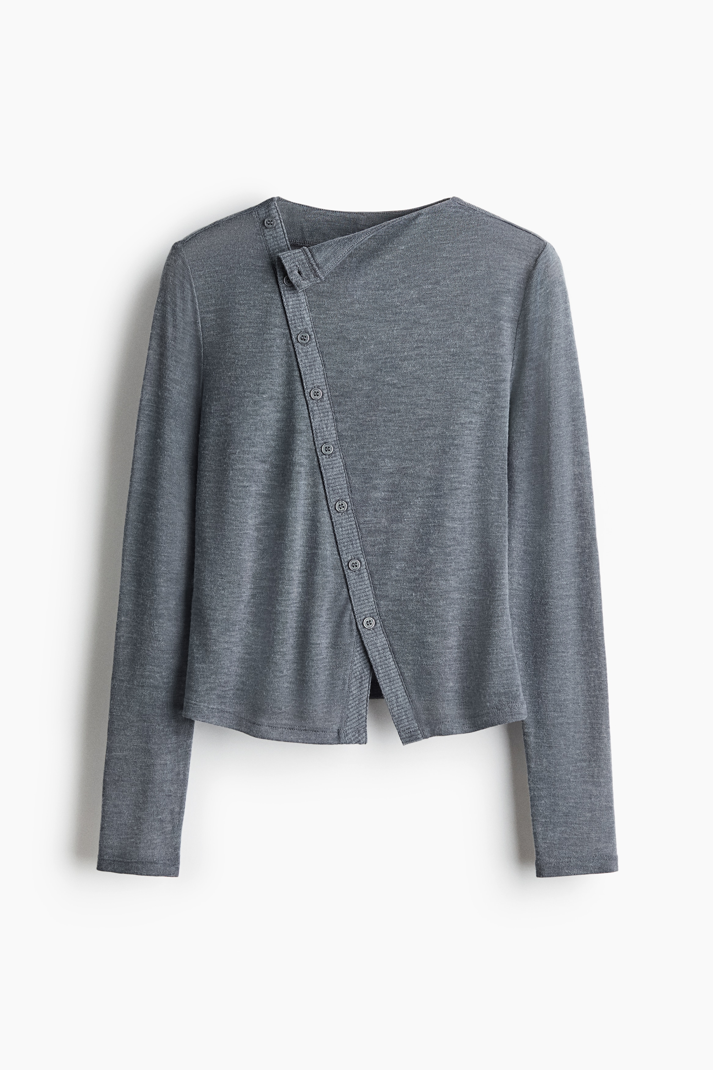 The model is wearing a grey fitted top in a soft knit, featuring a high neckline and a diagonal ribbed button placket running down the front. The long-sleeved top is paired with dark trousers.