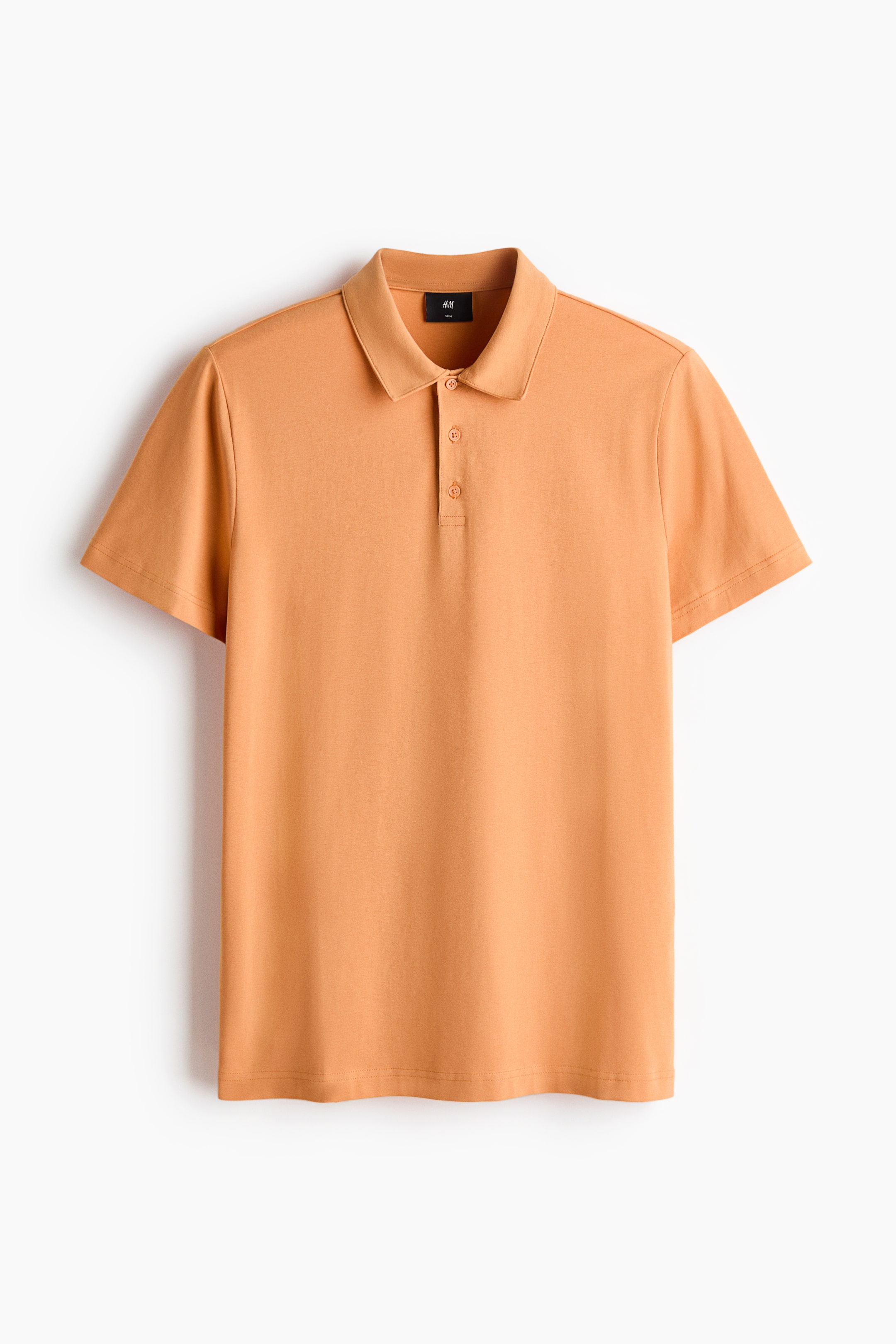 View larger image: A peach-orange polo shirt is shown from the front, featuring a pointed collar, a three-button placket with two buttons fastened, short sleeves, and a straight hem.