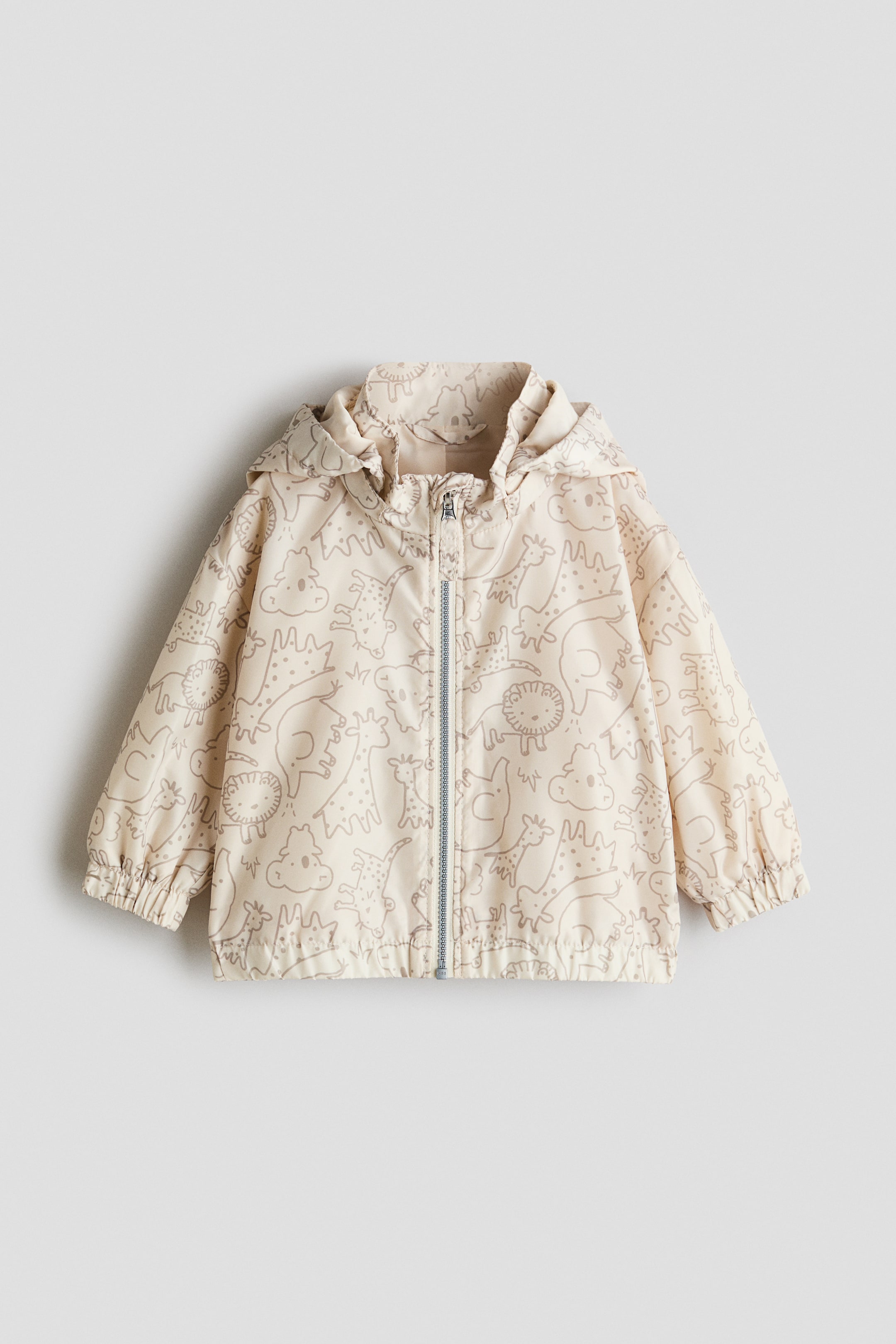 View larger image: A jacket is presented from the FRONT, featuring a light beige printed weave with brown animal illustrations. It displays a detachable hood with covered elastication, a stand-up collar and a front zip closure with an anti-chafe chin guard, while also featuring dropped shoulders and covered elastication at the cuffs and hem.