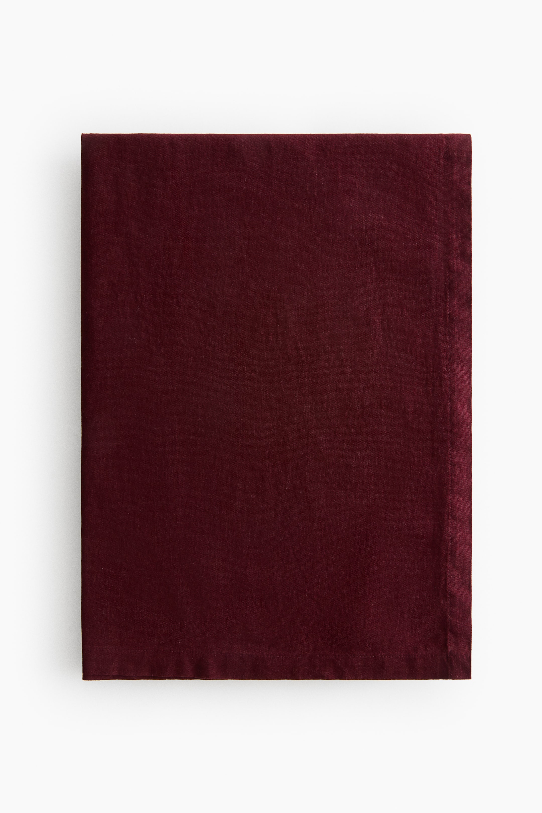 View larger image: A tablecloth made from a cotton-linen blend weave with a 240 thread count is shown in a deep red color, featuring a 2.5 cm folded hem along the edges.