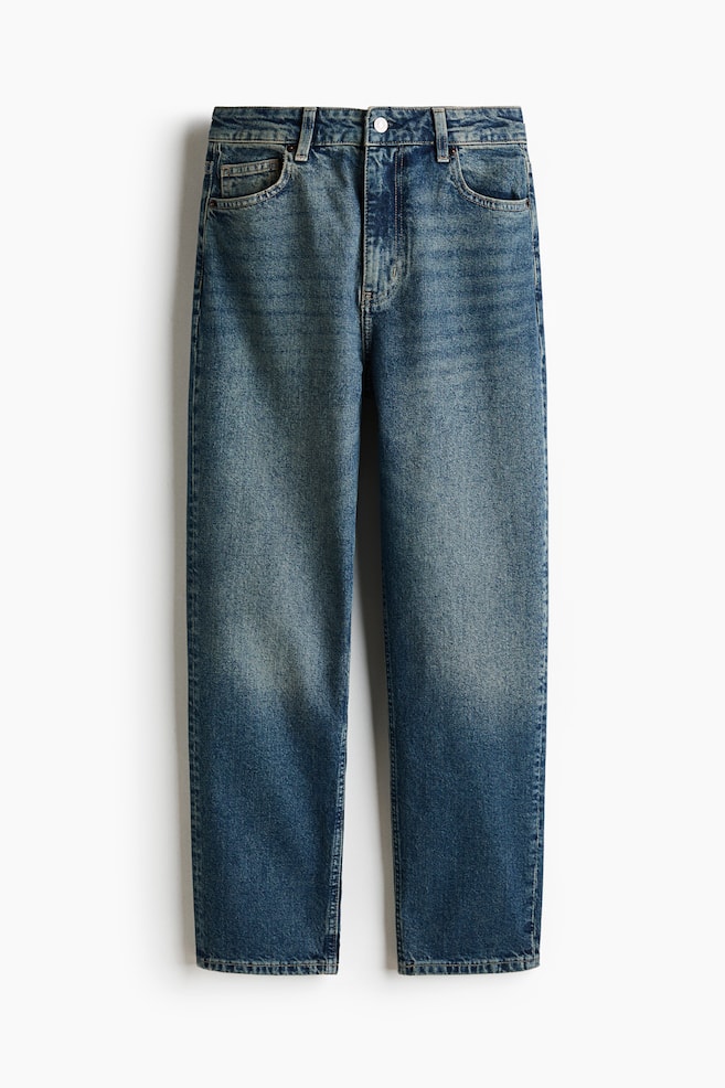 Blue denim 5-pocket jeans are displayed from the front, featuring a high waist with a zip fly and button fastening. They are designed with a straight leg that is slim from the hip to the thigh and tapers to an ankle-length hem, showcasing a faded wash. - 1
