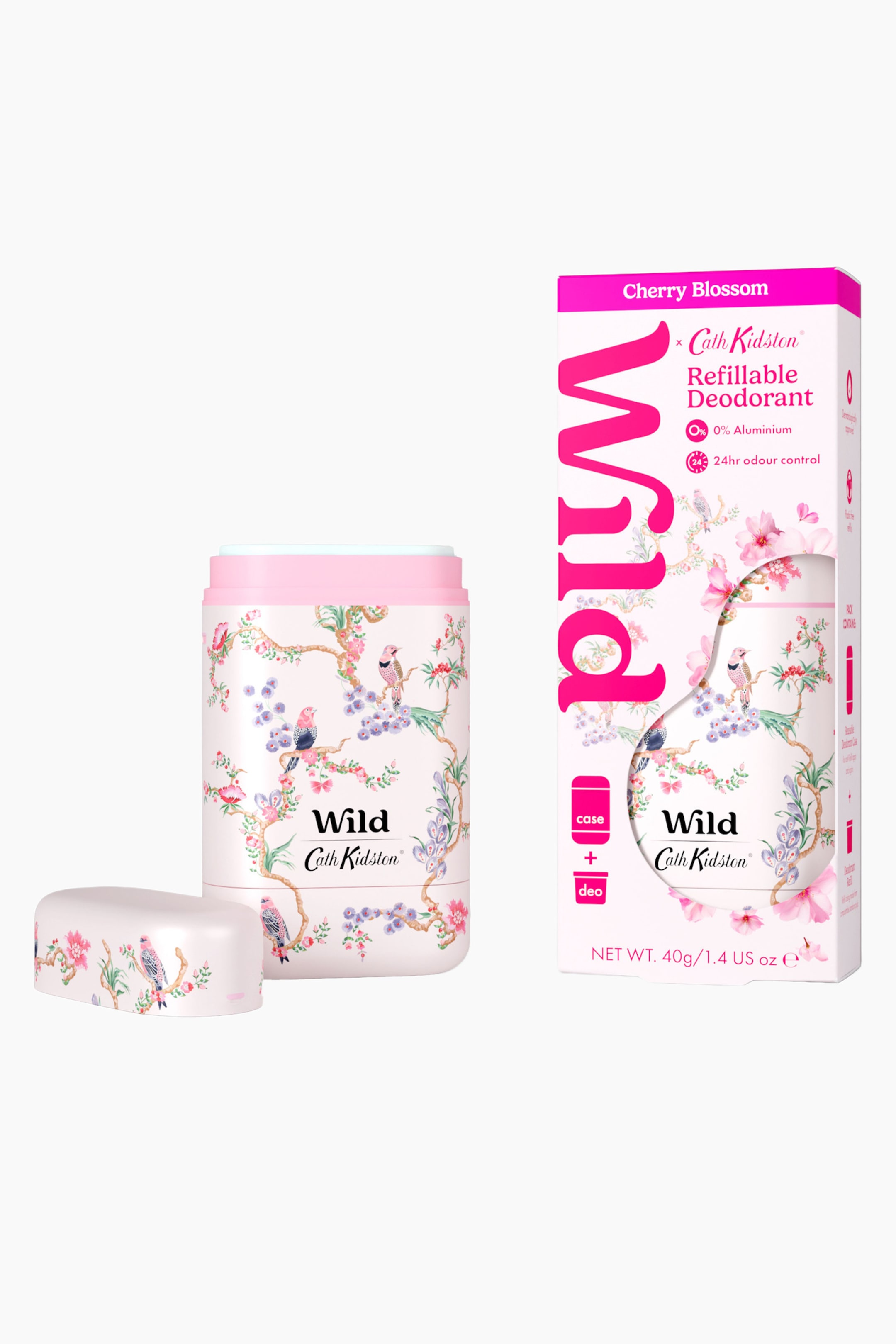 Visa större bild: Ett ljusrosa påfyllningsbart deodorantetui med en blom- och fågelillustration står upprätt, med tillhörande lock vilande till vänster. Till höger visar en vit och rosa kartongförpackning ett utskuret fönster som avslöjar samma dekorativa design.