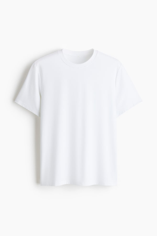 A white T-shirt is displayed, FRONT, featuring a plain design, a crew neck and short sleeves. - 1
