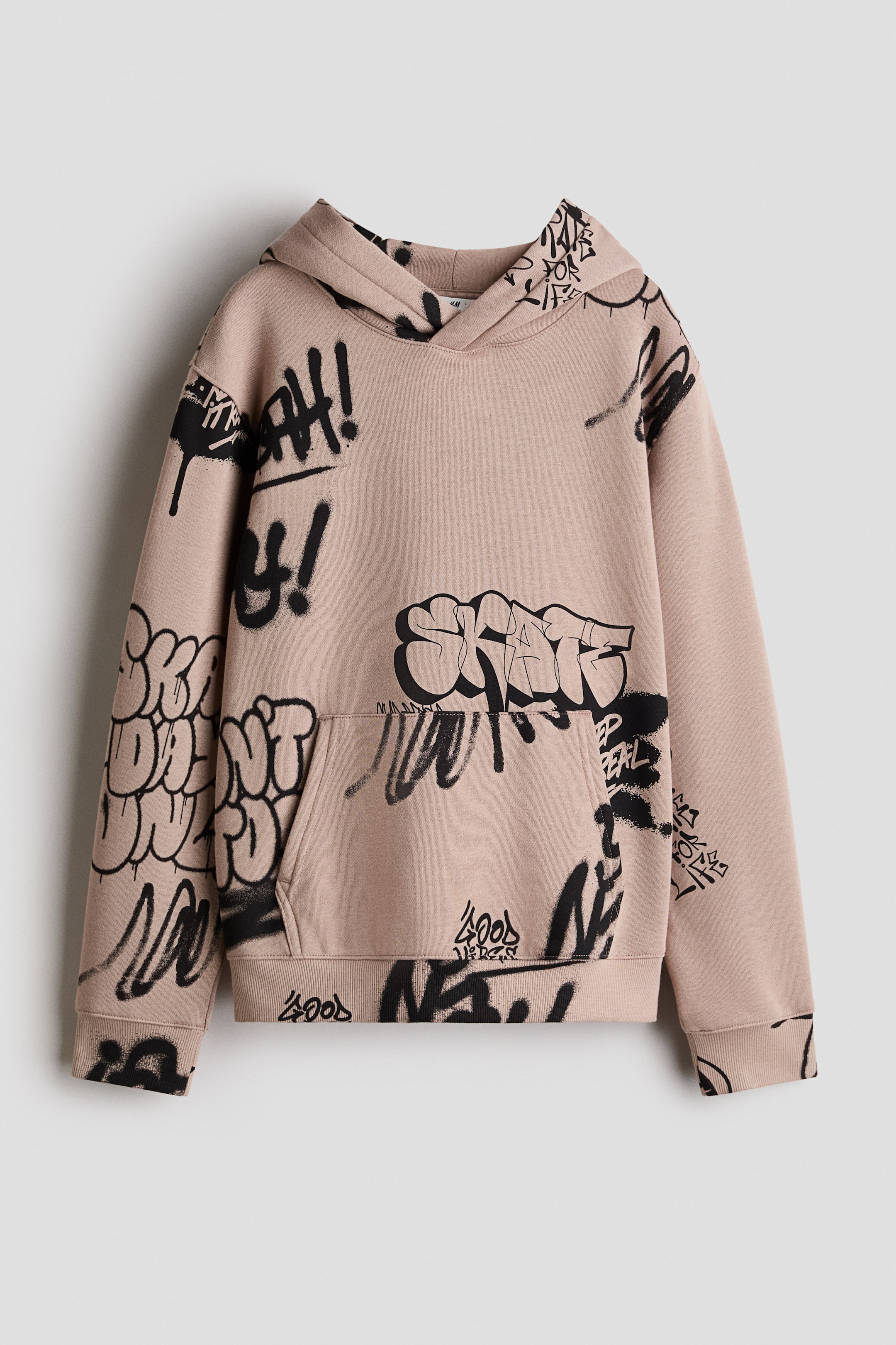 View larger image: A light brown hoodie showcases a black graffiti-style print covering its entire surface, as seen from the front. It features a wrapover hood, dropped shoulders, long sleeves, a kangaroo pocket, and ribbed cuffs and hem.