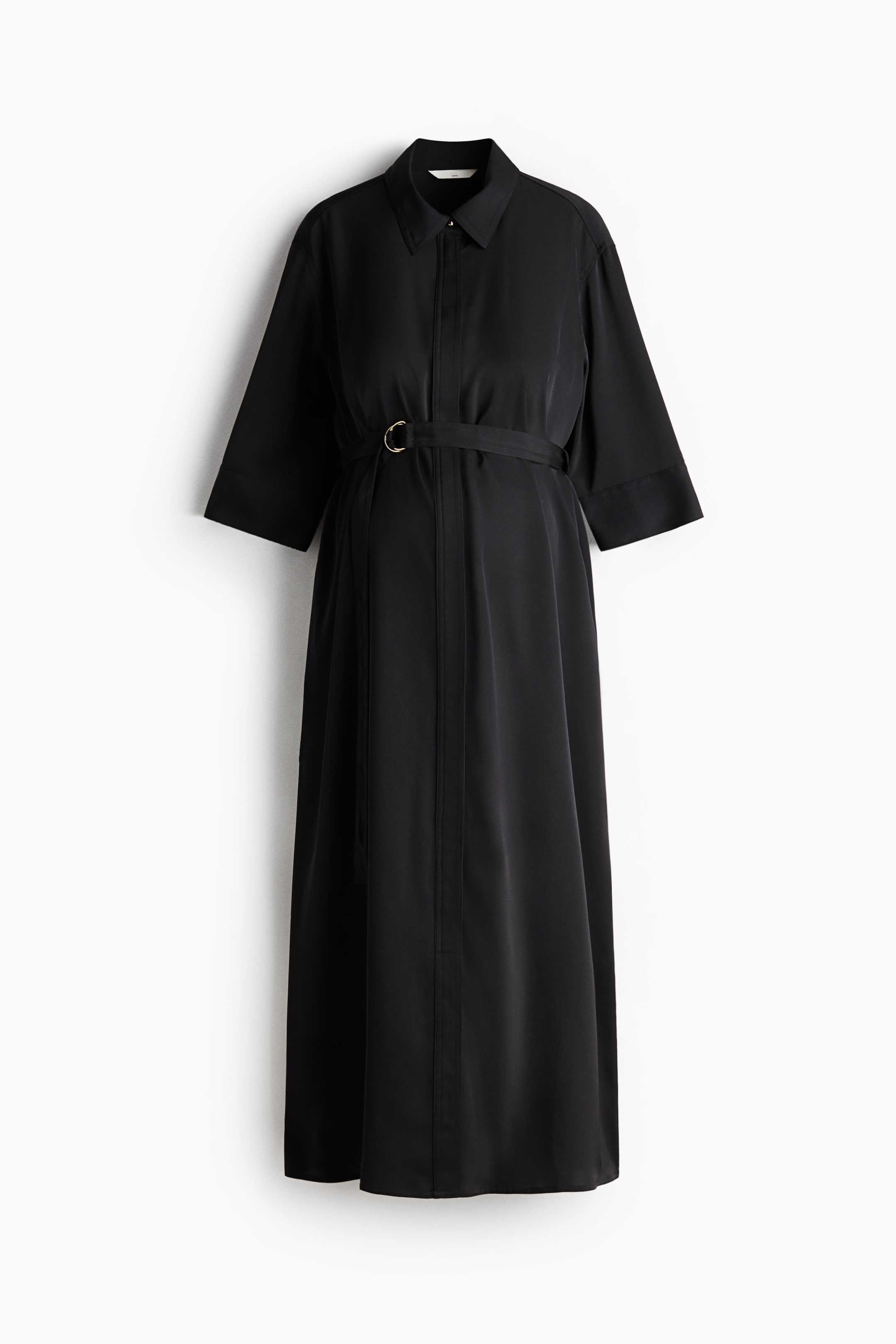 View larger image: A black calf-length dress is shown from the FRONT, featuring a collar and a concealed button placket down the front. It is designed with dropped shoulders, 3/4-length sleeves with cuffs, and a detachable belt with a single gold-colored D-ring cinching below the bust.