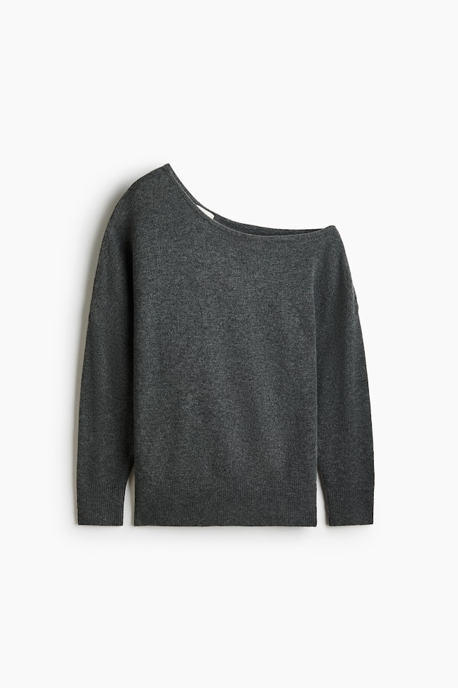 A dark grey heathered knit jumper featuring a wide boat neckline, presented off-the-shoulder on the left side. It showcases long sleeves with ribbed cuffs and a ribbed bottom hem. - 1