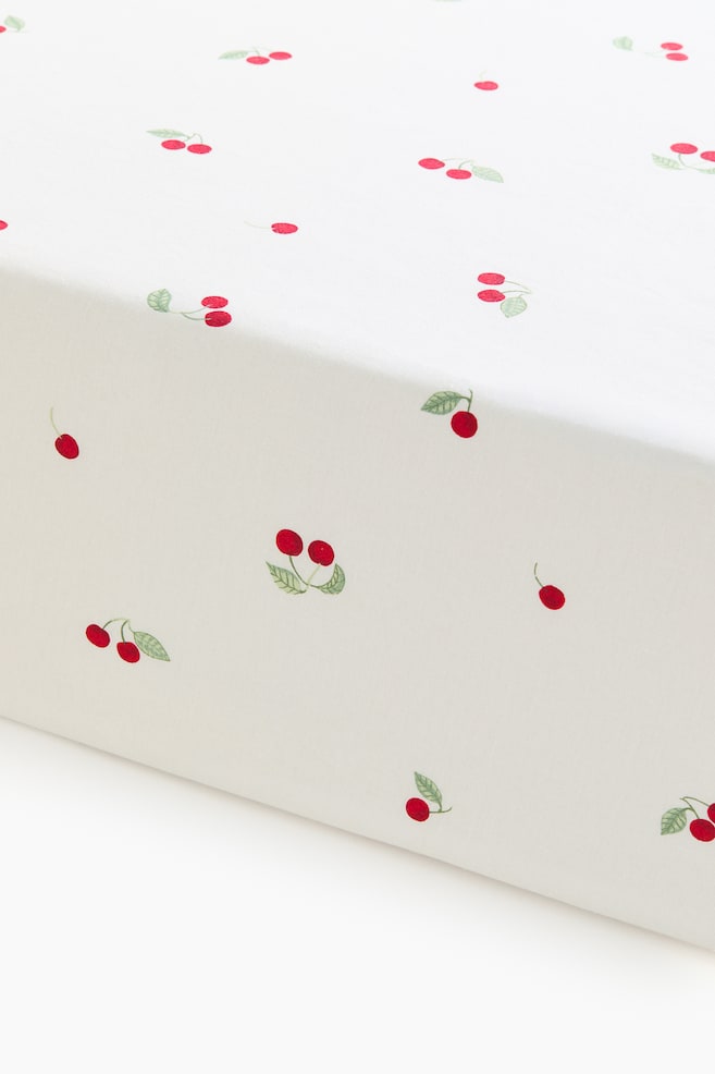 Patterned Cotton Fitted Sheet - White/cherries/Green/clover/Pink/floral/Light beige/dinosaurs/Light green/vehicles/Light pink/floral/Light taupe/floral/Light beige/unicorns/Light blue/fish/White/dotted/Light yellow/oranges - 1