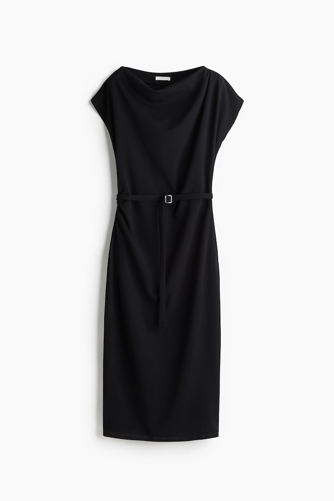 A black dress is featuring a draped neckline and short cap sleeves. It is cinched at the waist by a thin black belt with a rectangular buckle, with one end hanging loosely, and is extending to a midi length in a straight silhouette. - 1